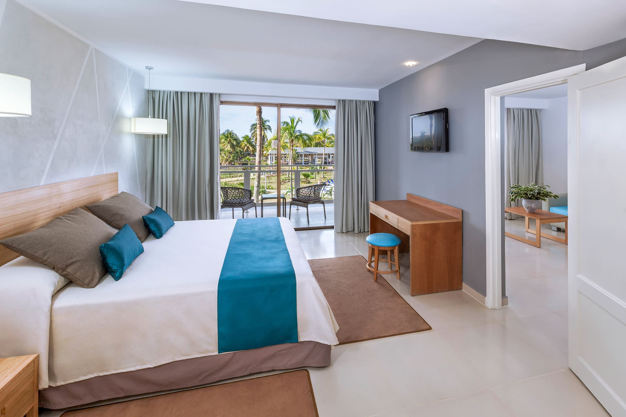 a bedroom with a bed and a television