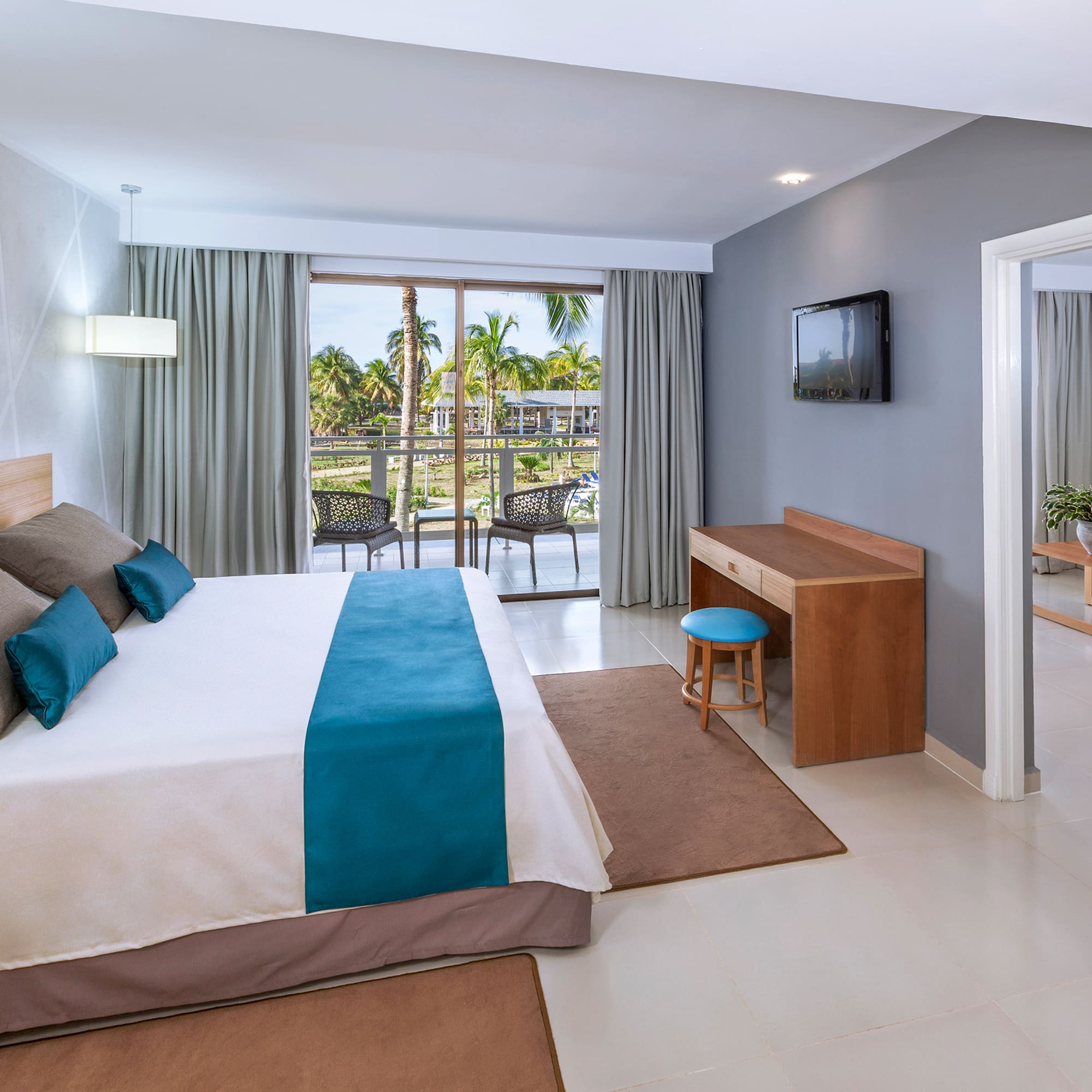 a bedroom with a bed and a television