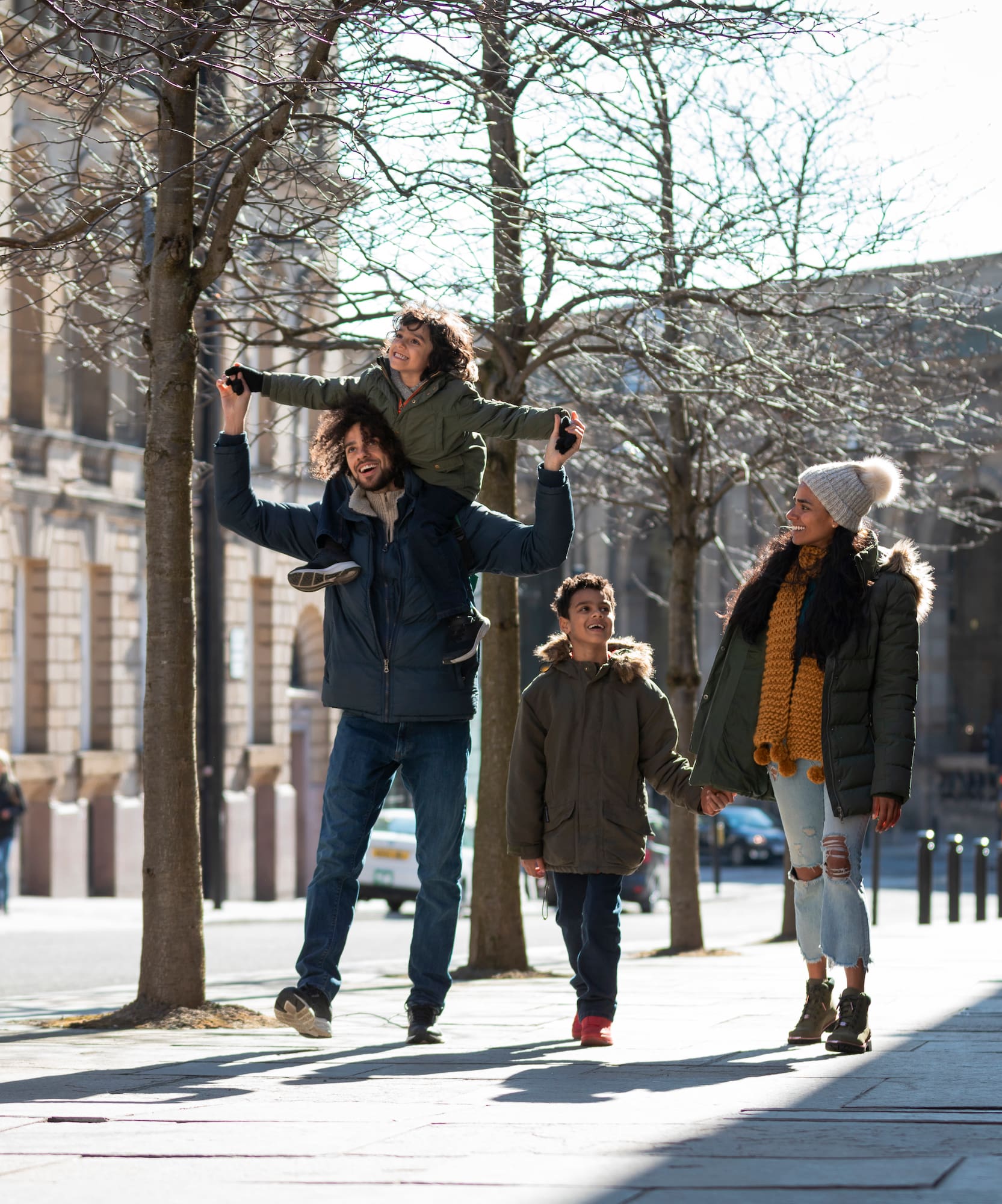 a man holding a child on his shoulders