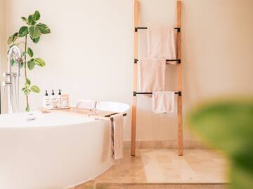 a bathroom with a tub and a towel rack