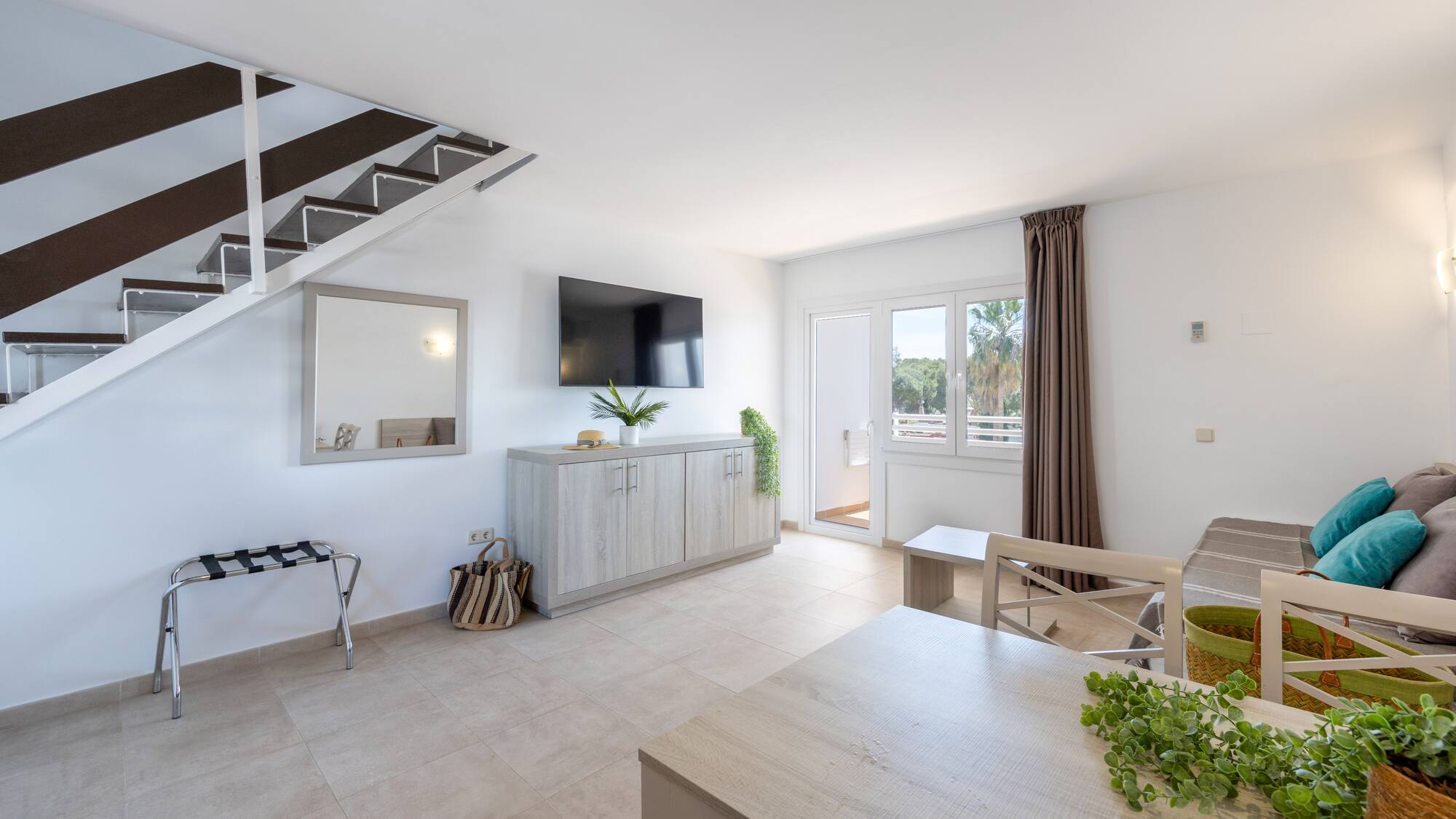 a room with a tv and a staircase