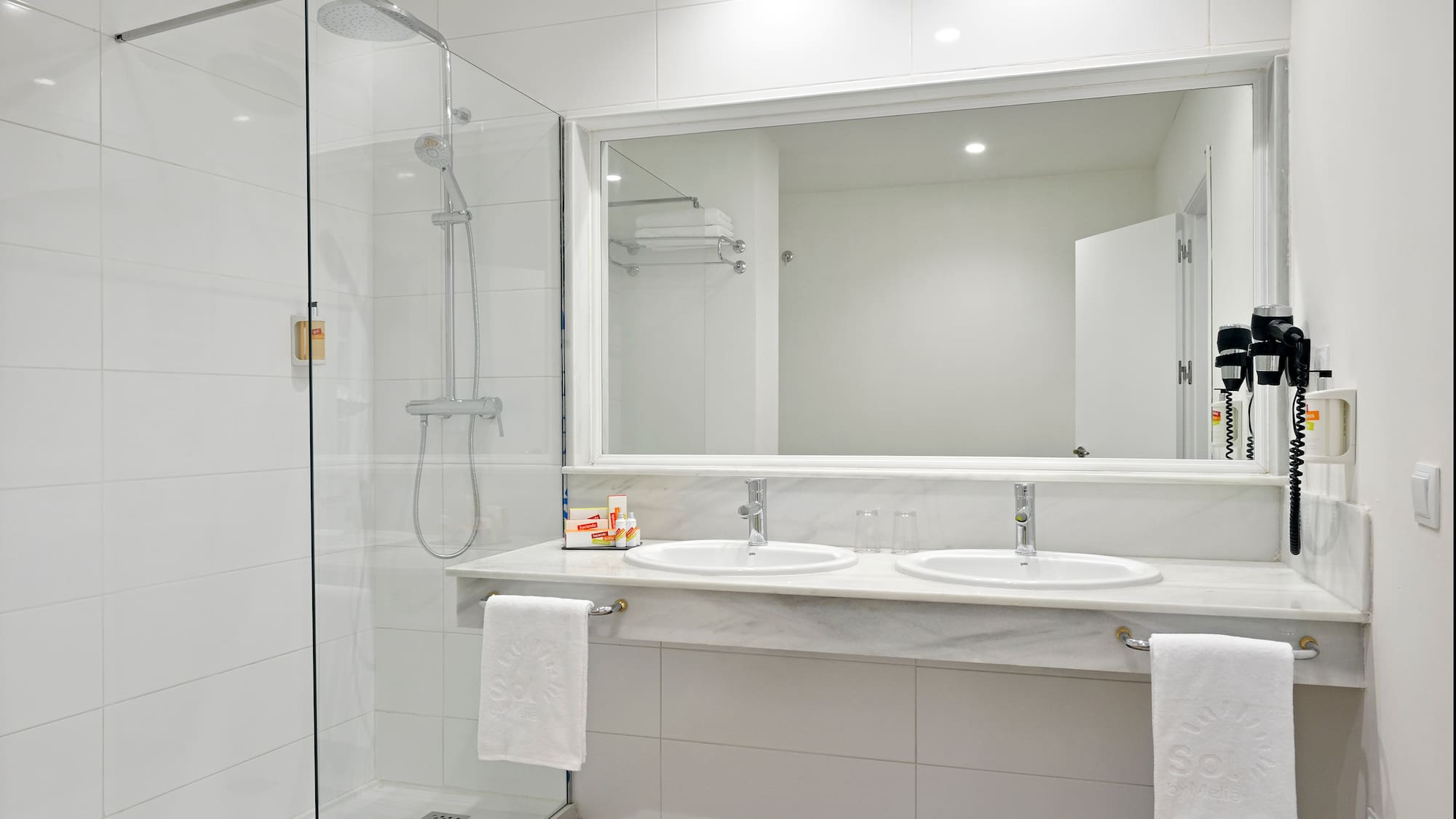 a bathroom with a shower and two sinks