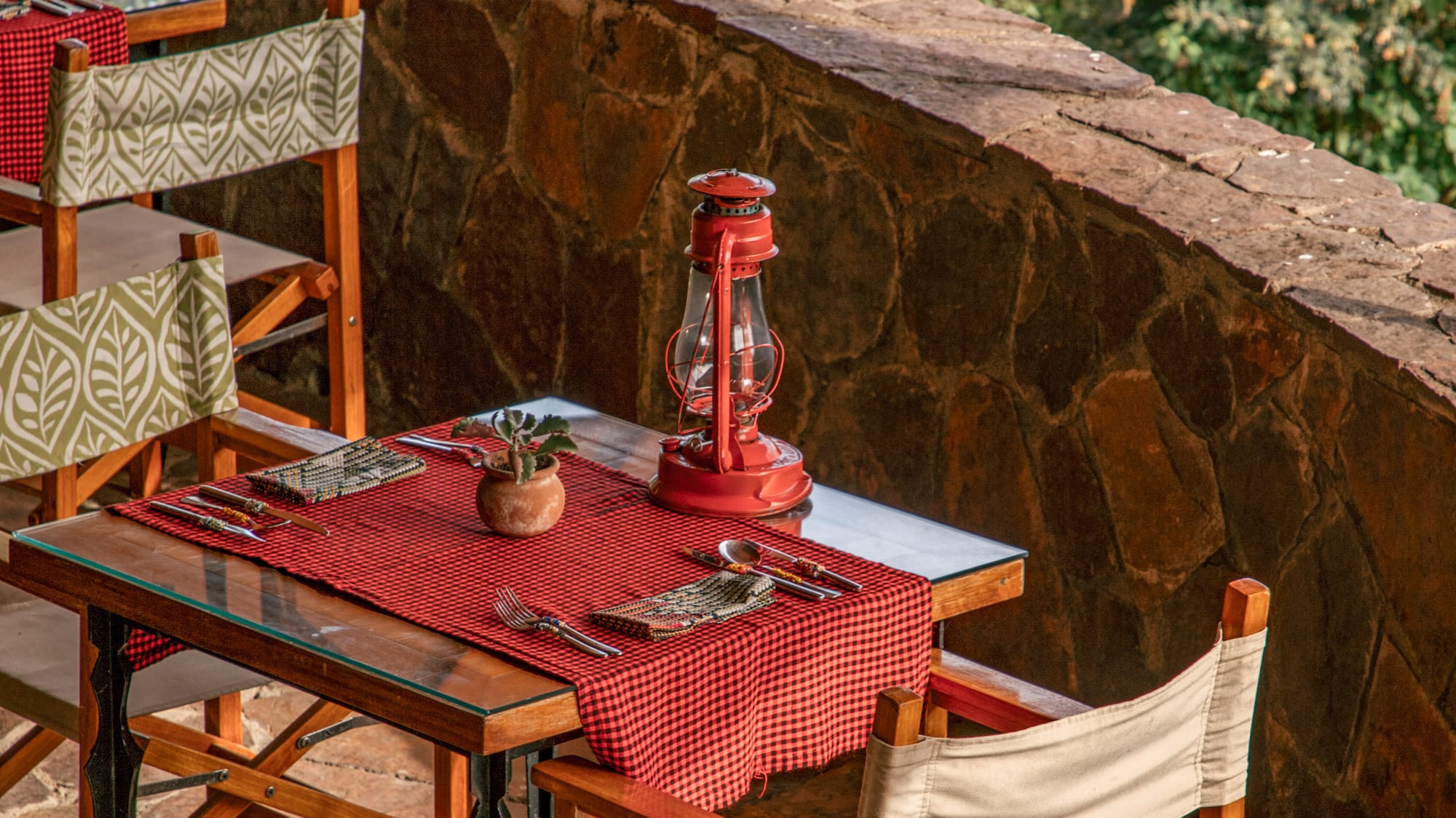 a table with chairs and a lantern on it
