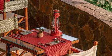 a table with chairs and a lantern on it