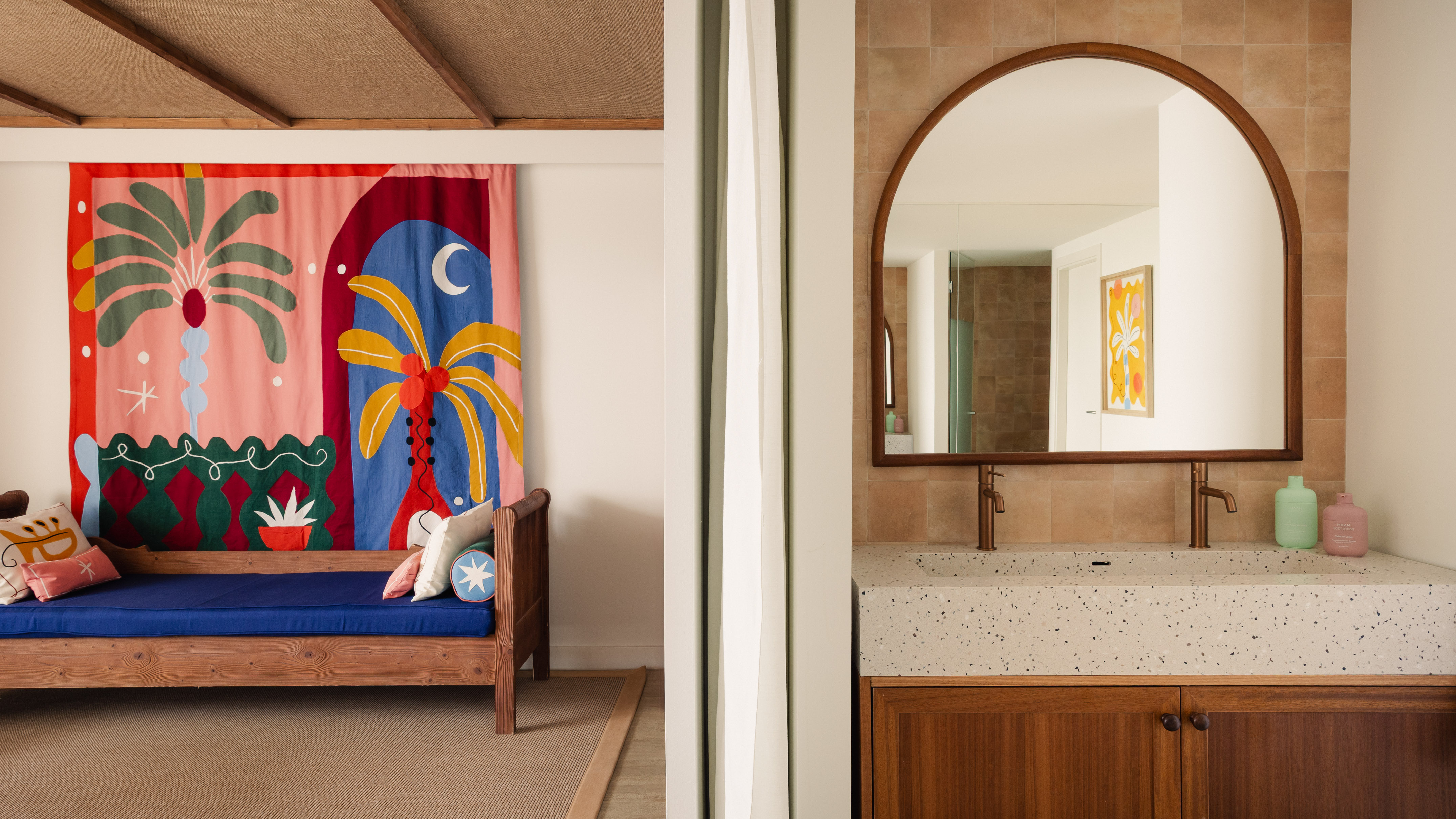 Tropical tapestry, daybed, and modern bathroom vanity with arched mirror.