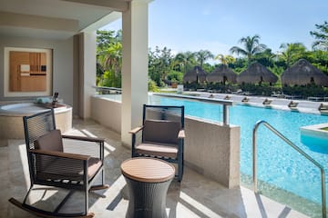 a pool with chairs and a table