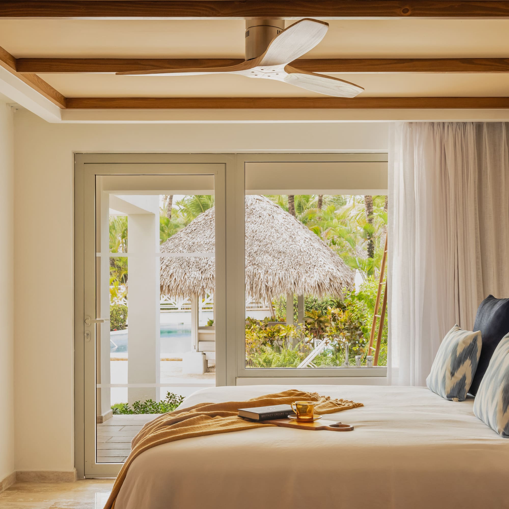 a bed with a fan and a window