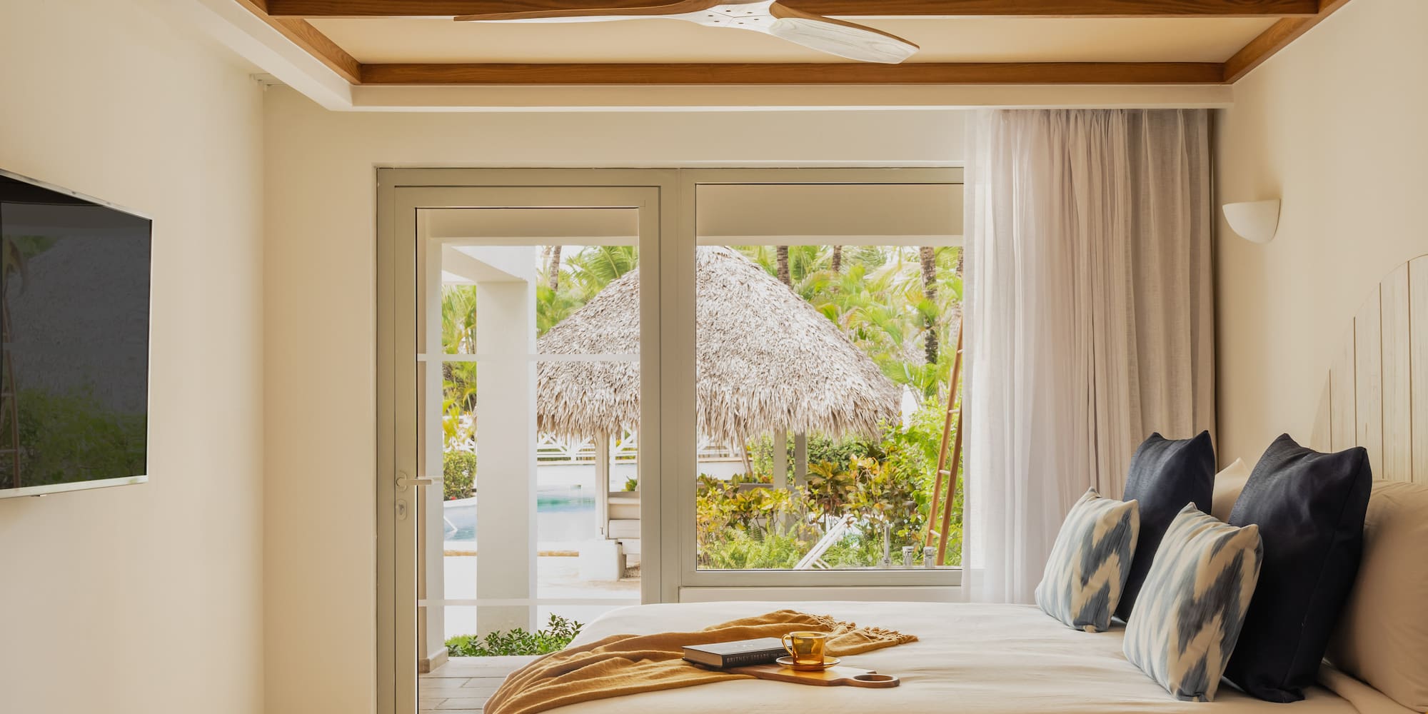 a bed with a fan and a window