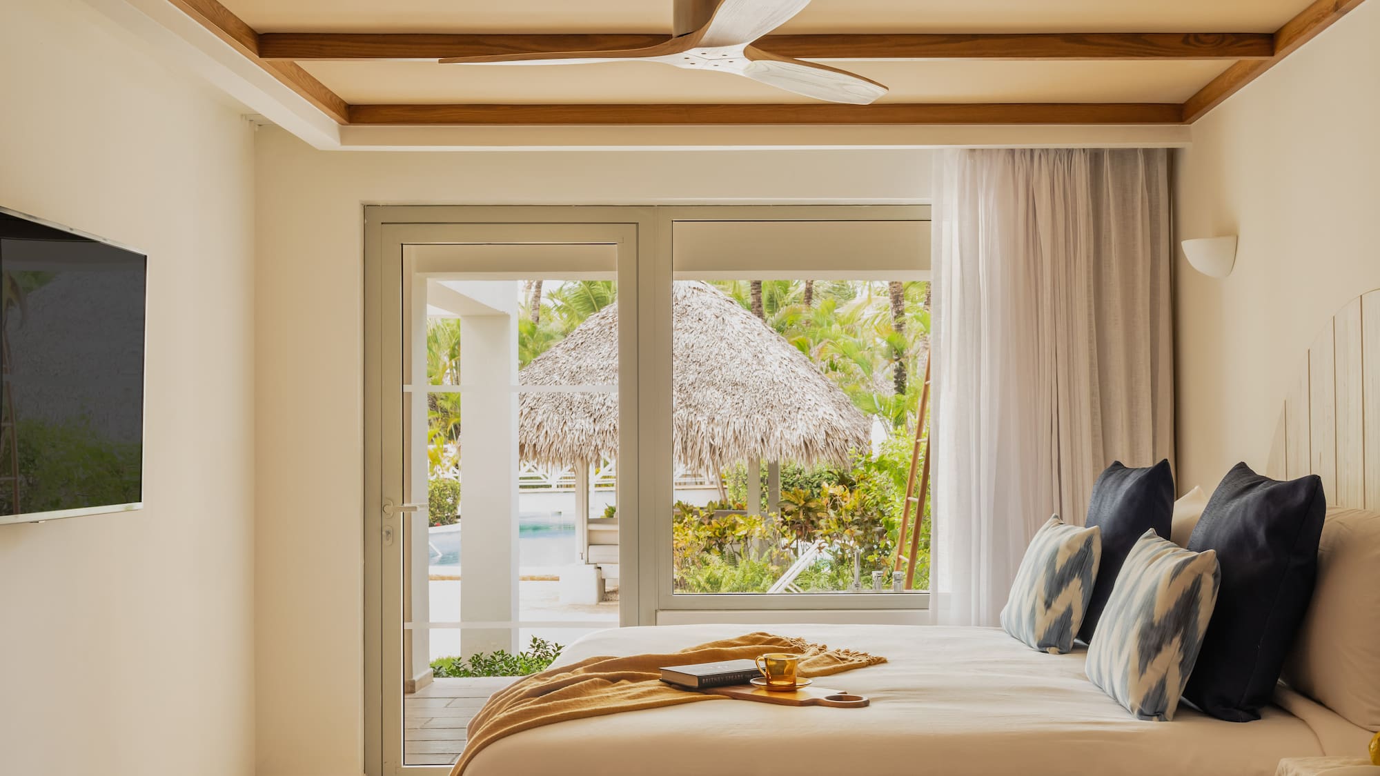 a bed with a fan and a window