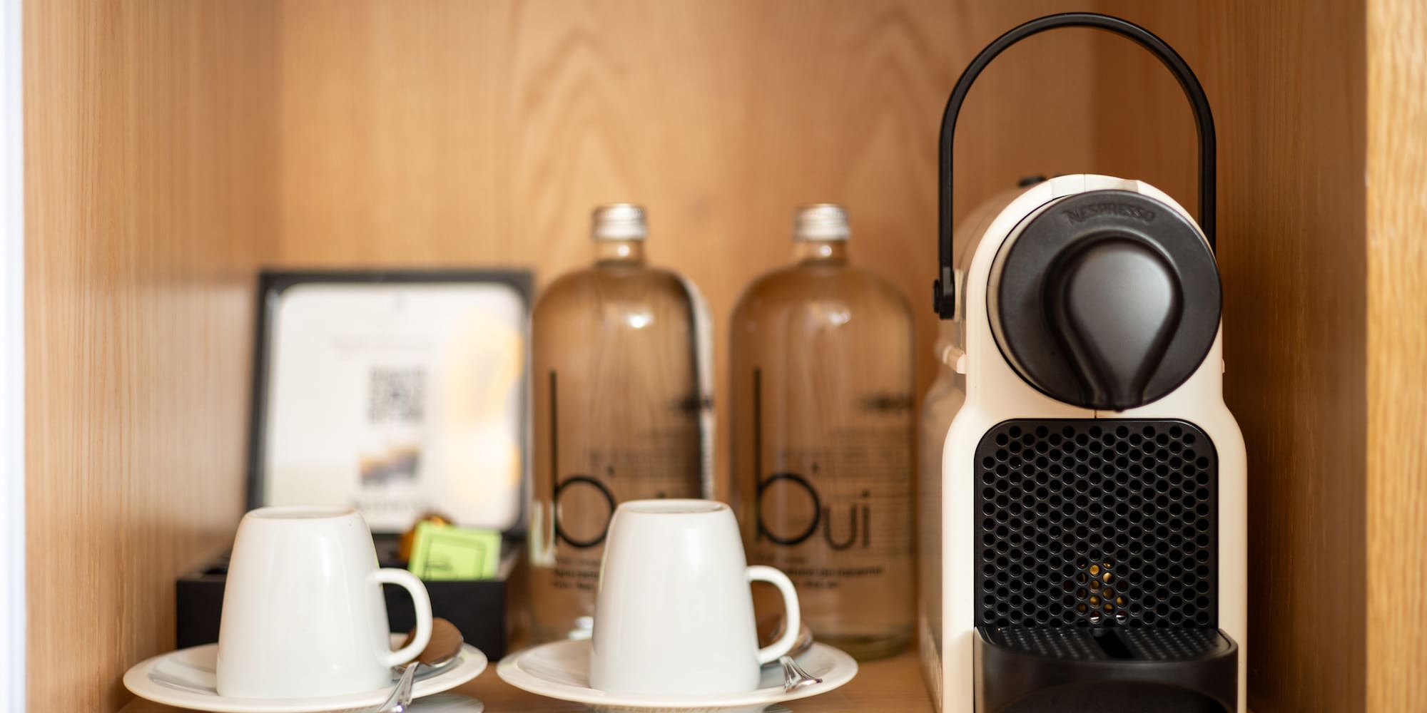 a coffee machine and cups on a table