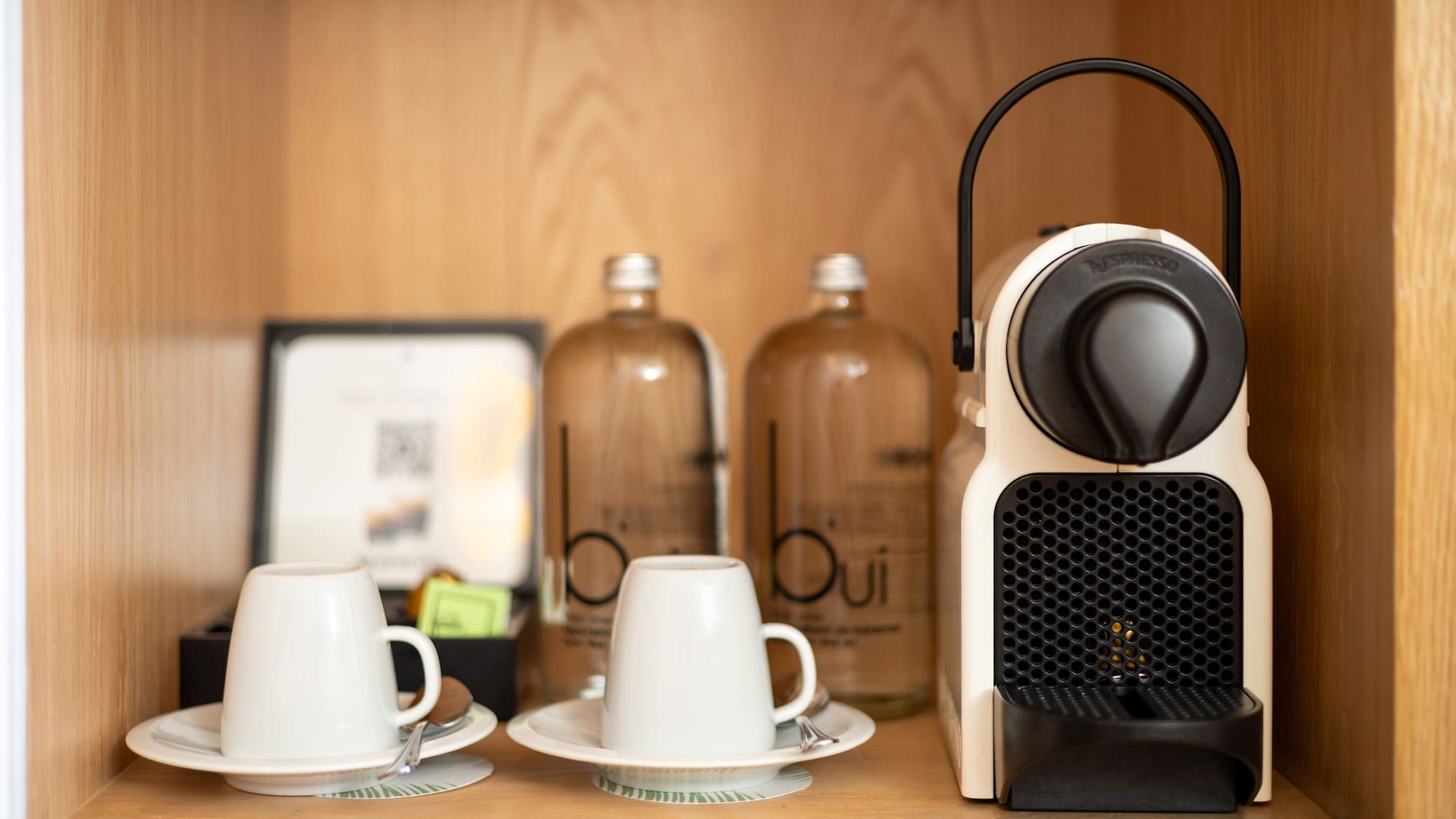 a coffee machine and cups on a table