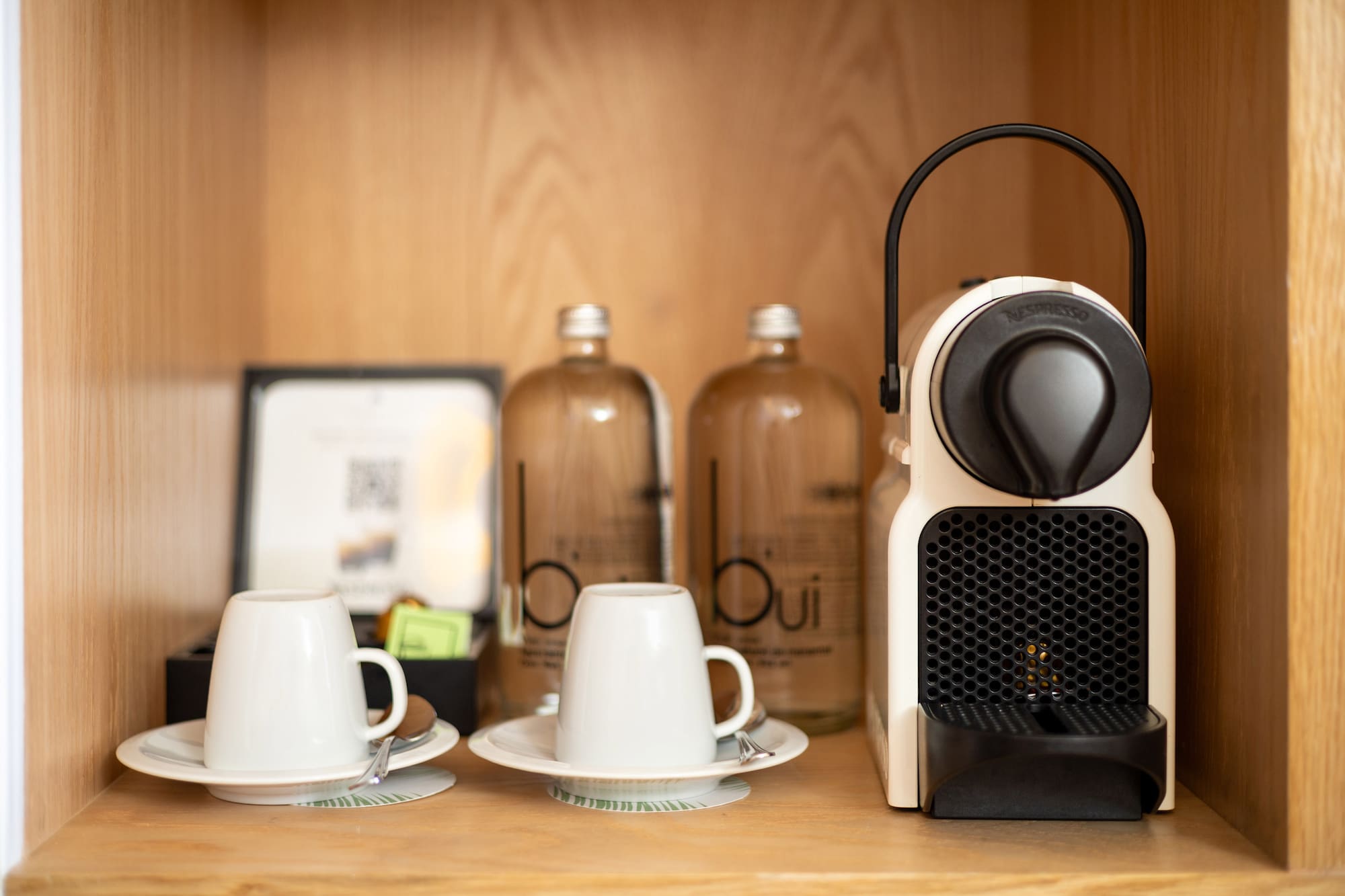 a coffee machine and cups on a table