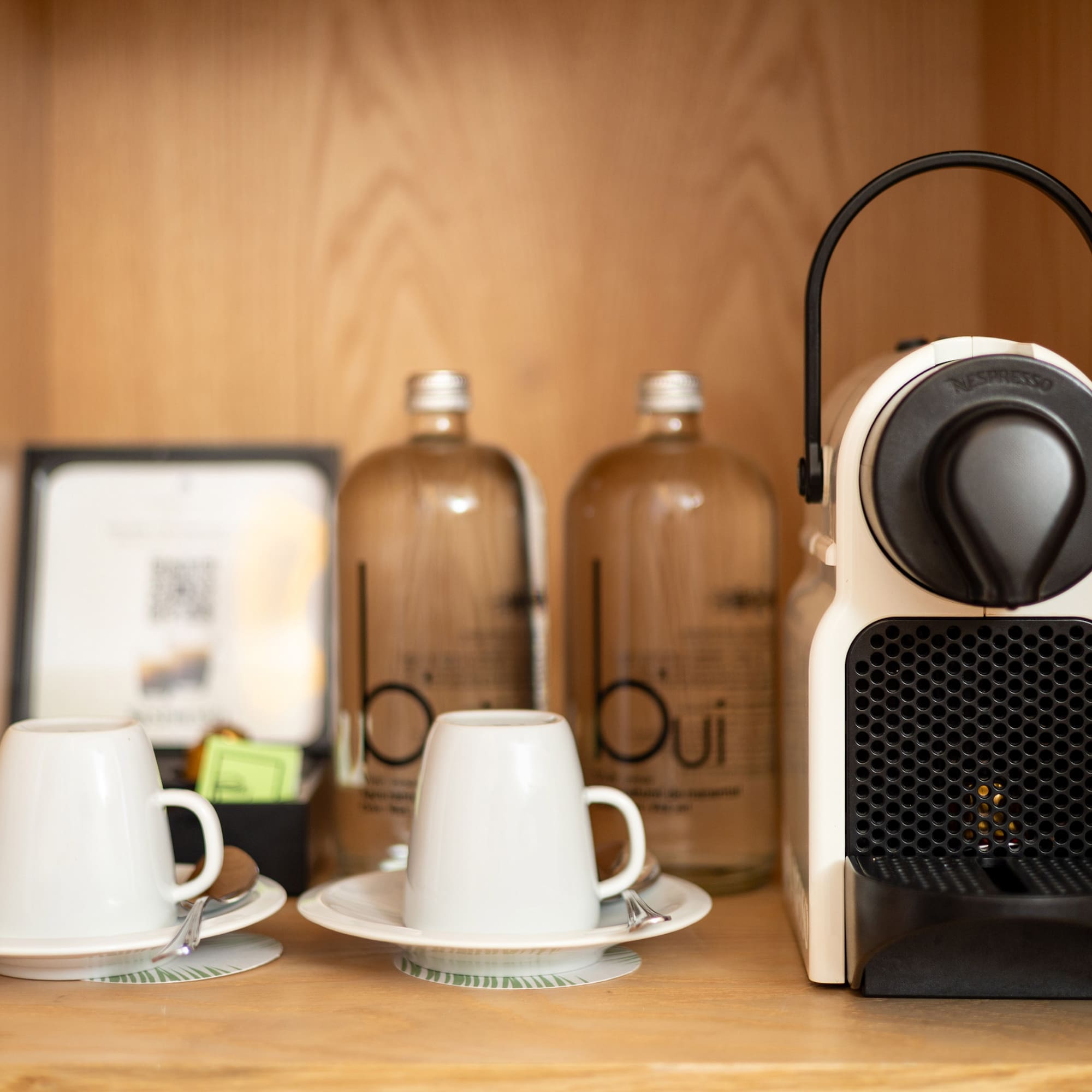 a coffee machine and cups on a table