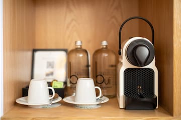 a coffee machine and cups on a table