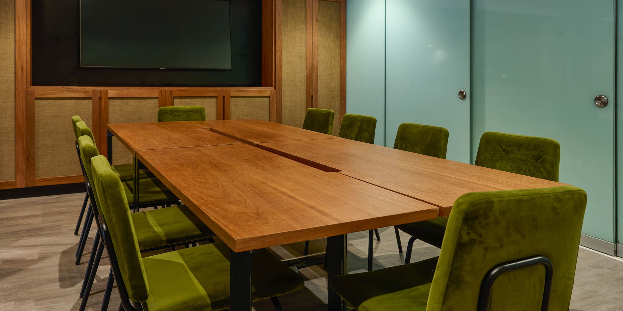 a table with green chairs in a room