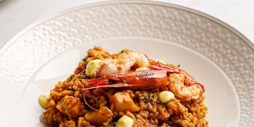 a plate of rice with shrimp and sauce