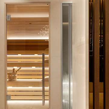 a sauna with a glass door