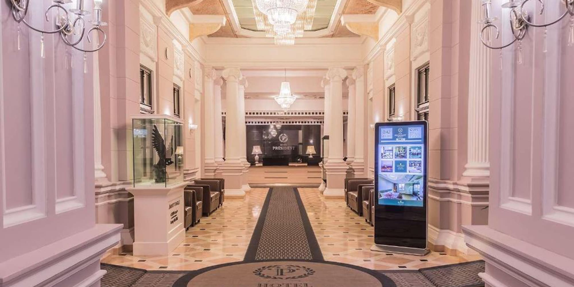 a large hall with columns and a large screen