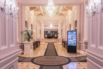 a large hall with columns and a large screen