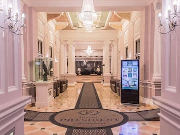 a large hall with columns and a large screen