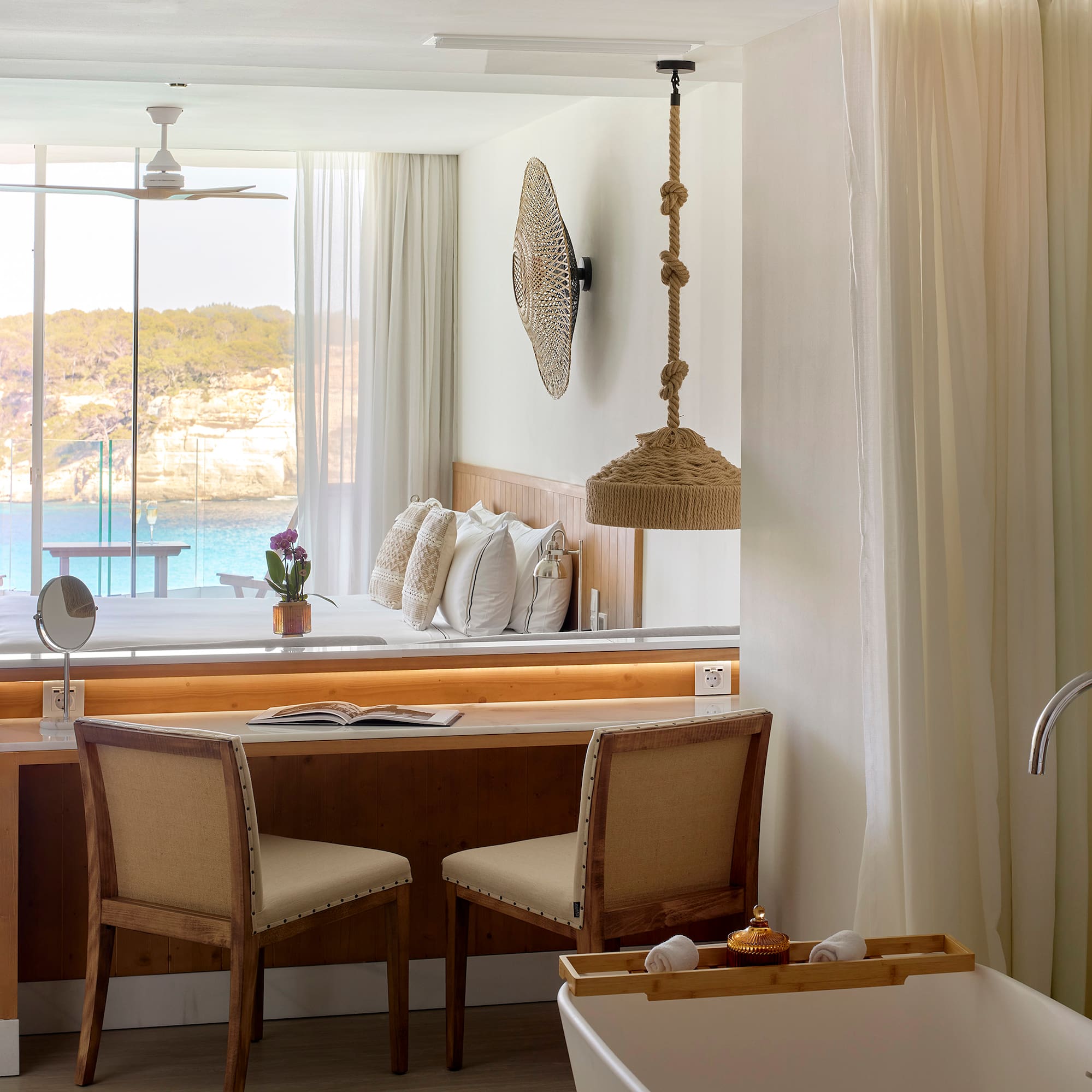 a room with a desk and chairs and a bathtub