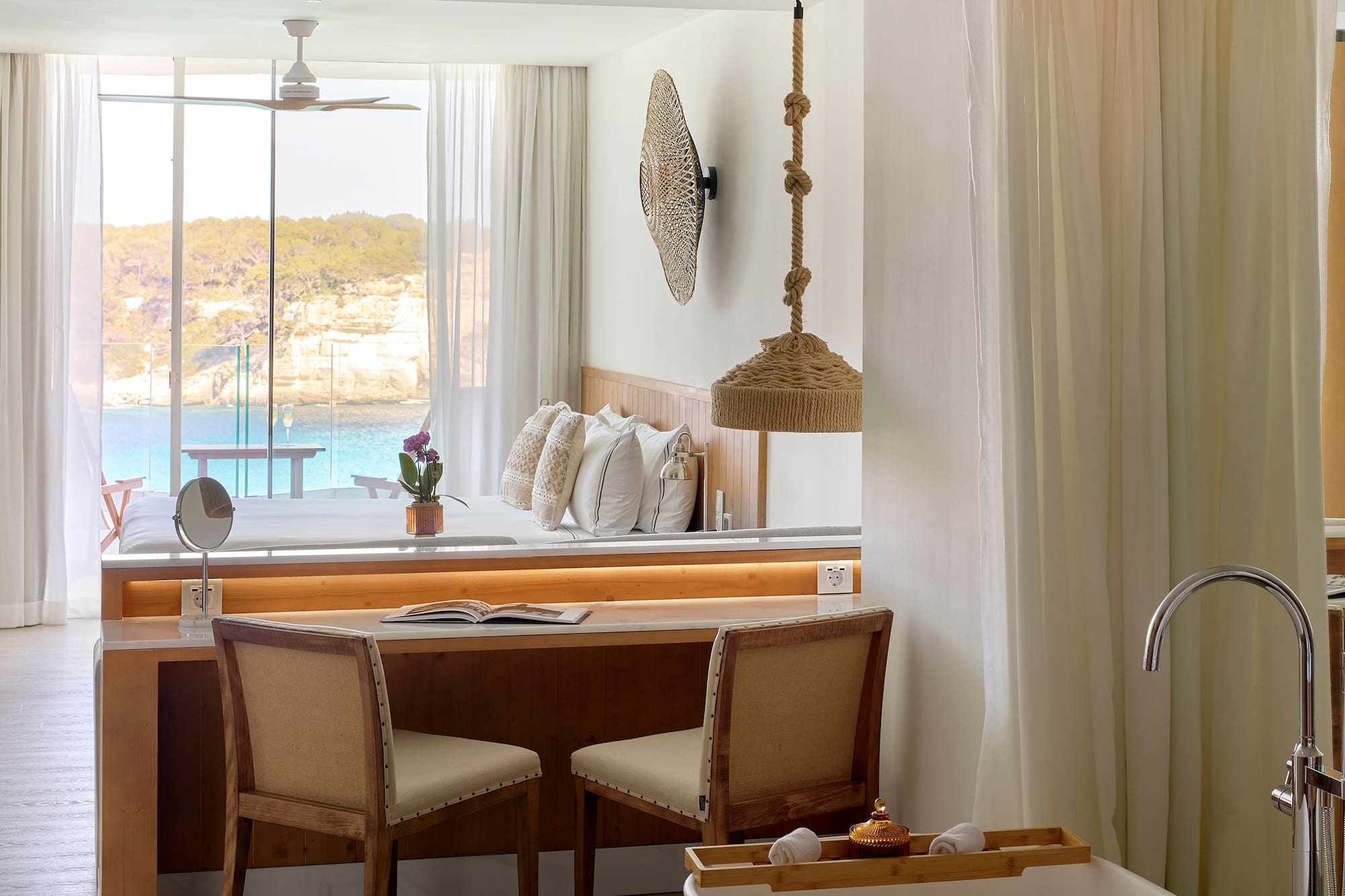 a room with a desk and chairs and a bathtub