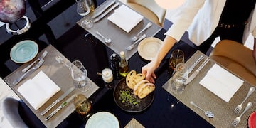 a person serving food at a table