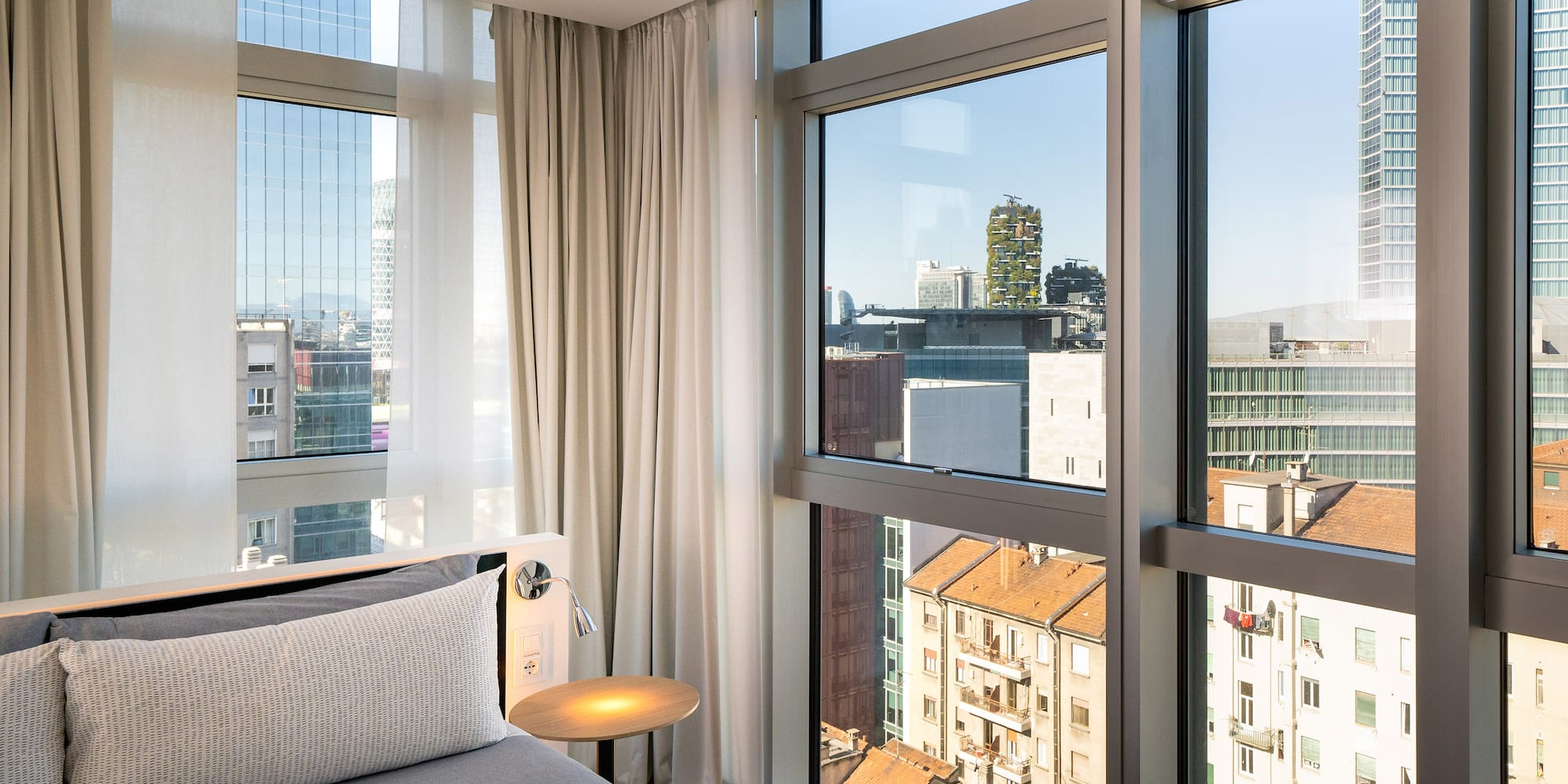 a bedroom with a bed and a table and a window