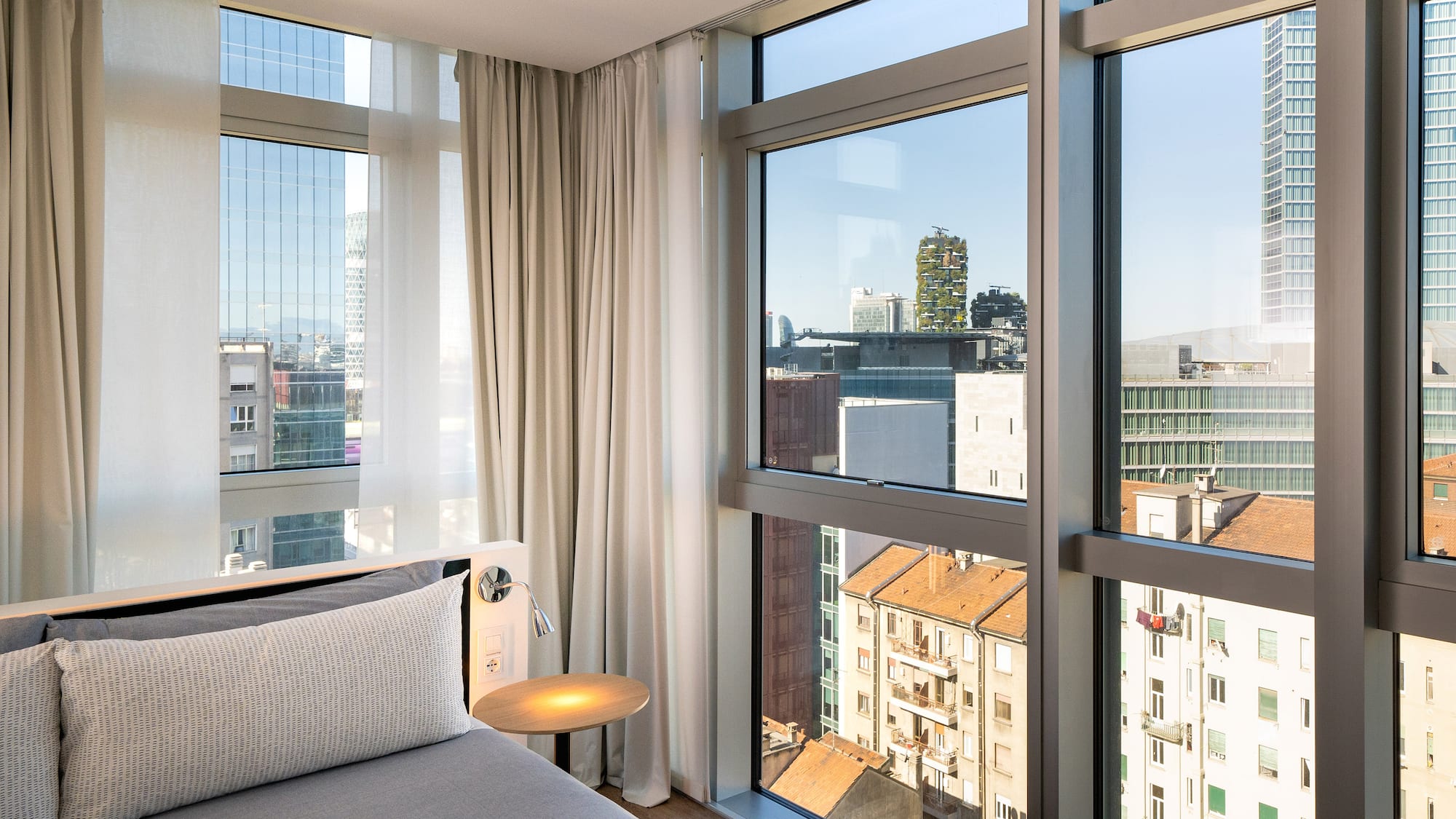 a bedroom with a bed and a table and a window