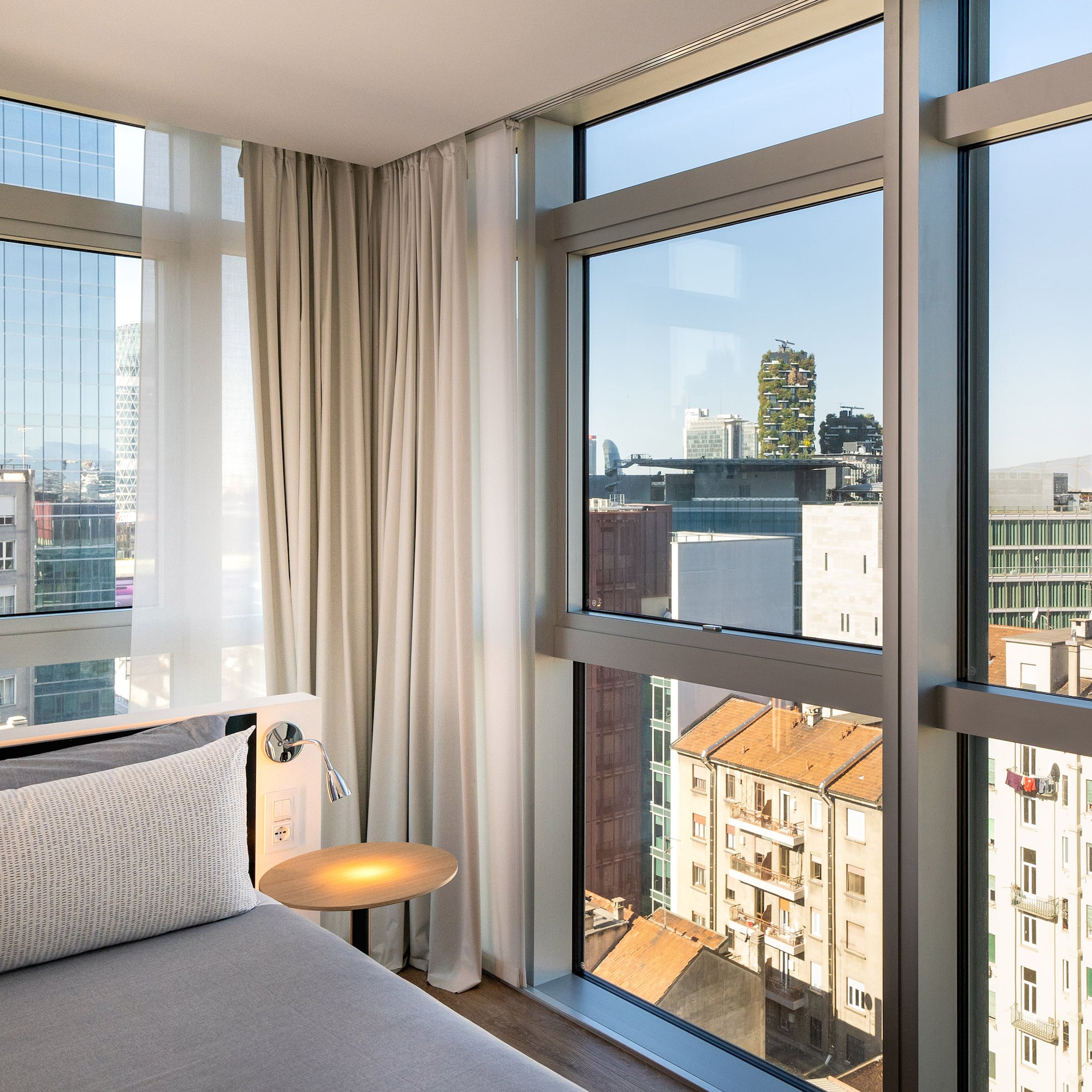 a bedroom with a bed and a table and a window