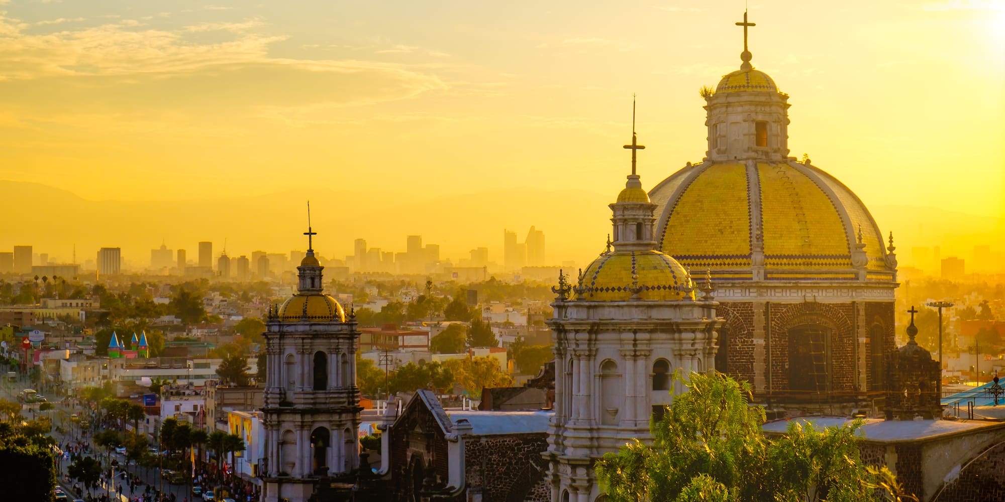 a city with a large building with a yellow dome