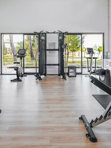 a room with exercise equipment and exercise bikes