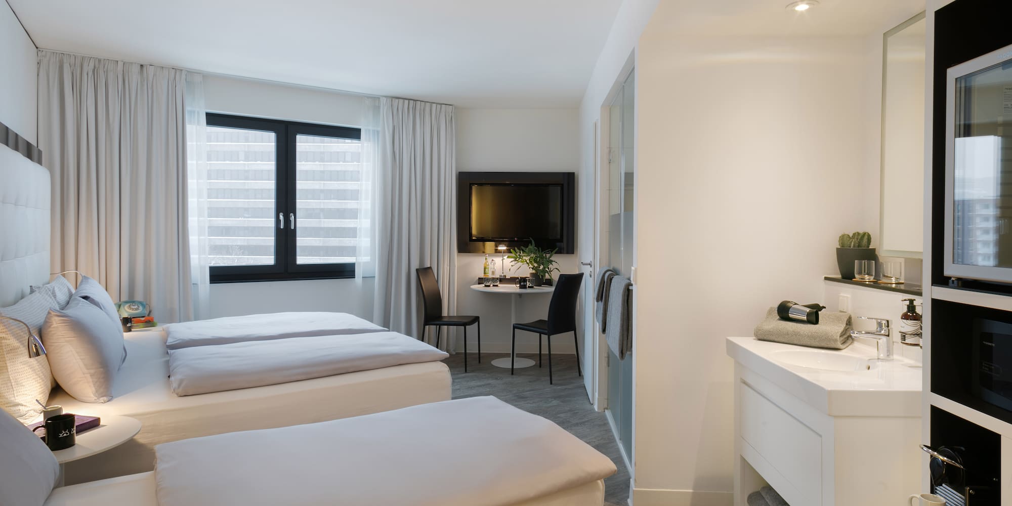 a room with two beds and a tv