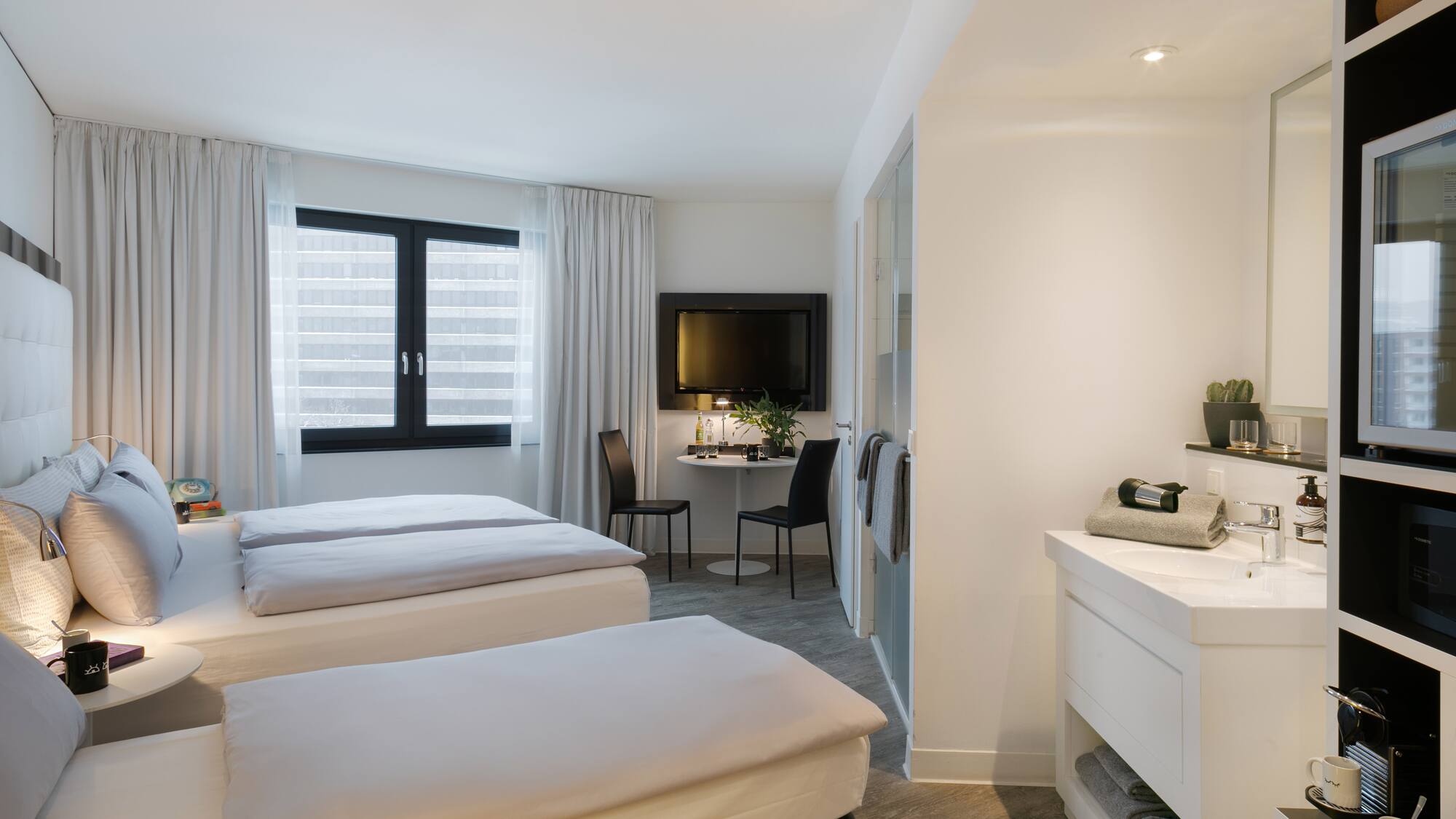 a room with two beds and a tv