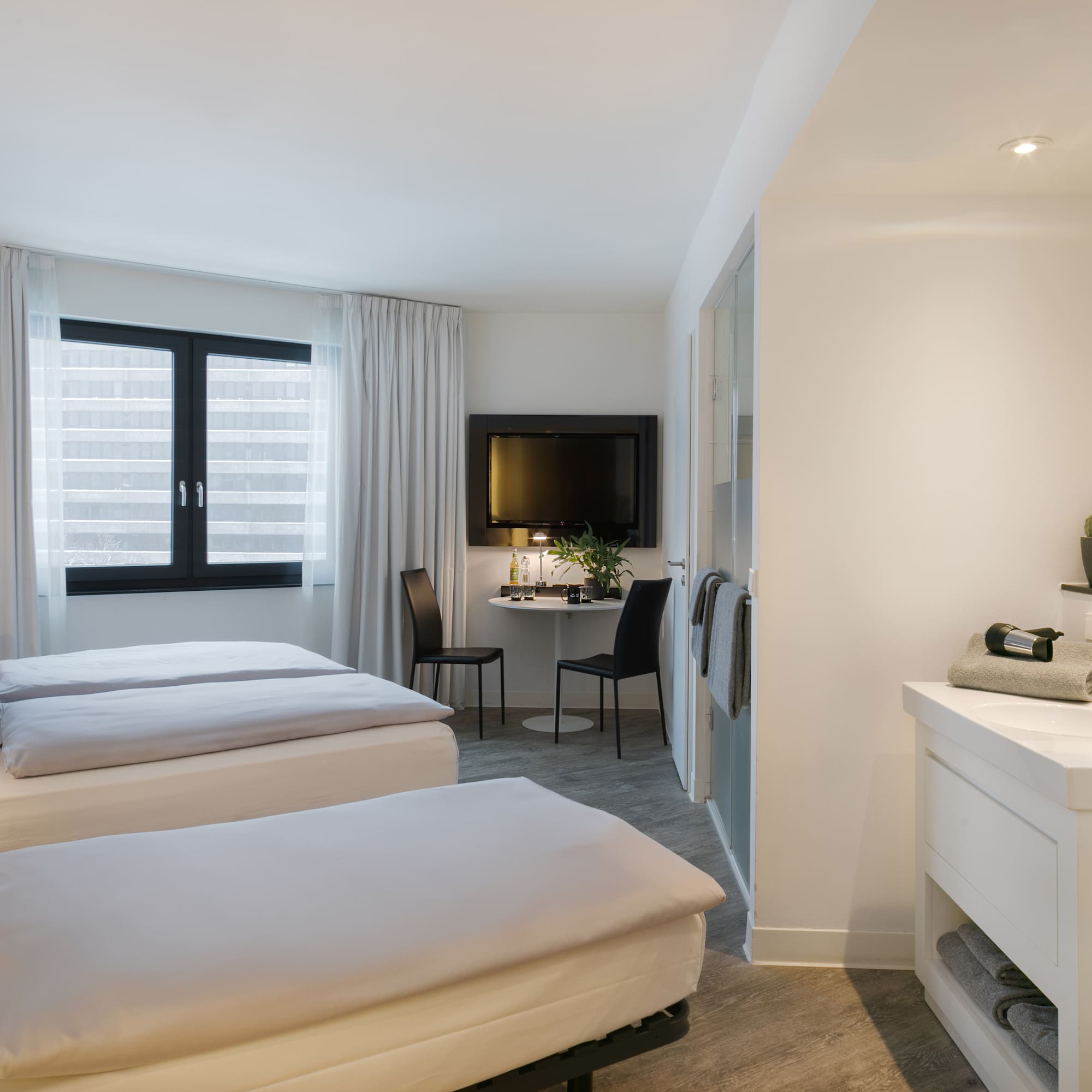 a room with two beds and a tv