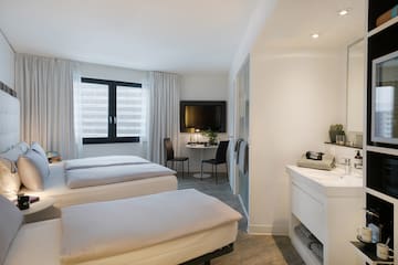 a room with two beds and a tv