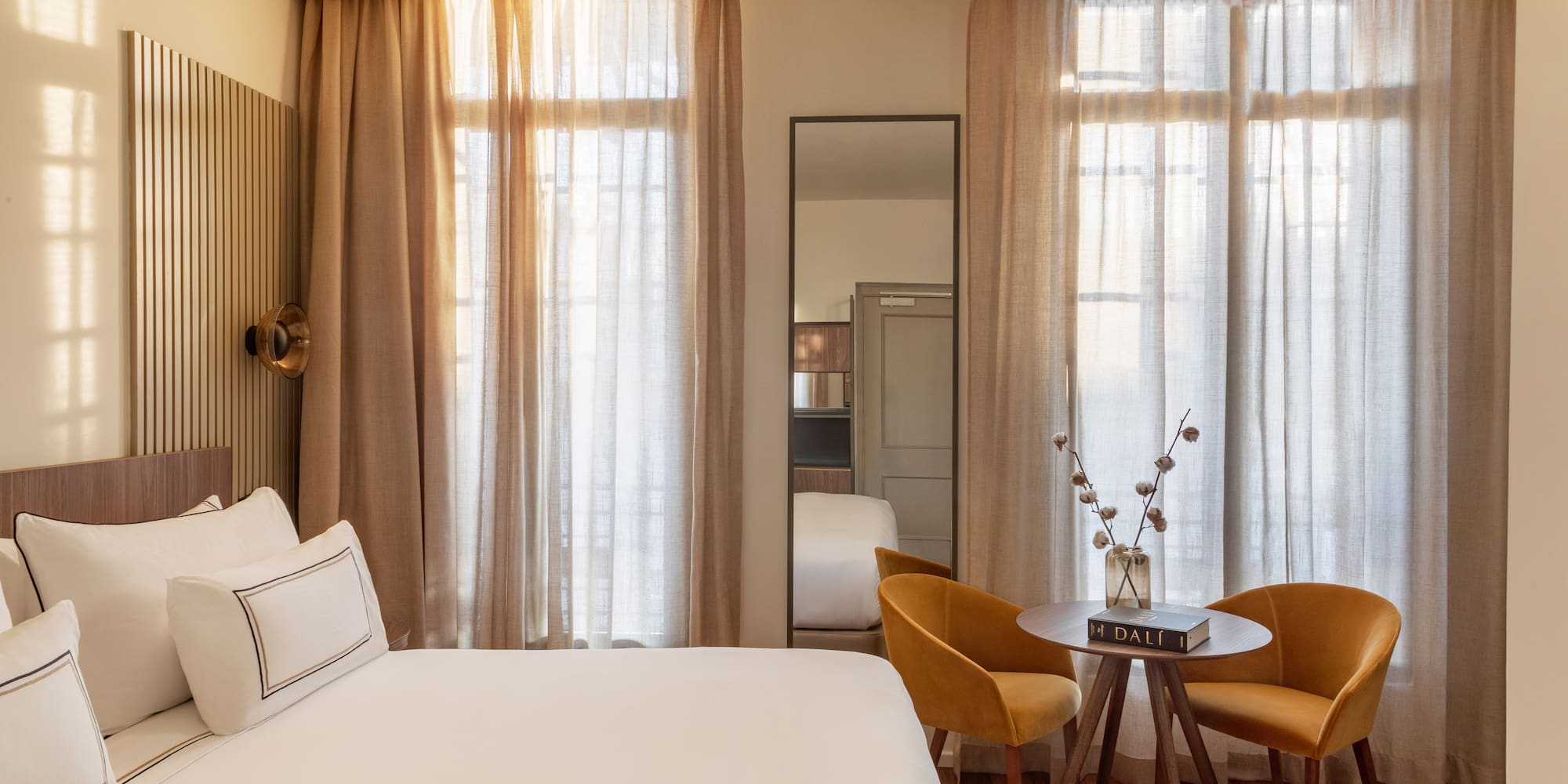 a room with a bed and chairs