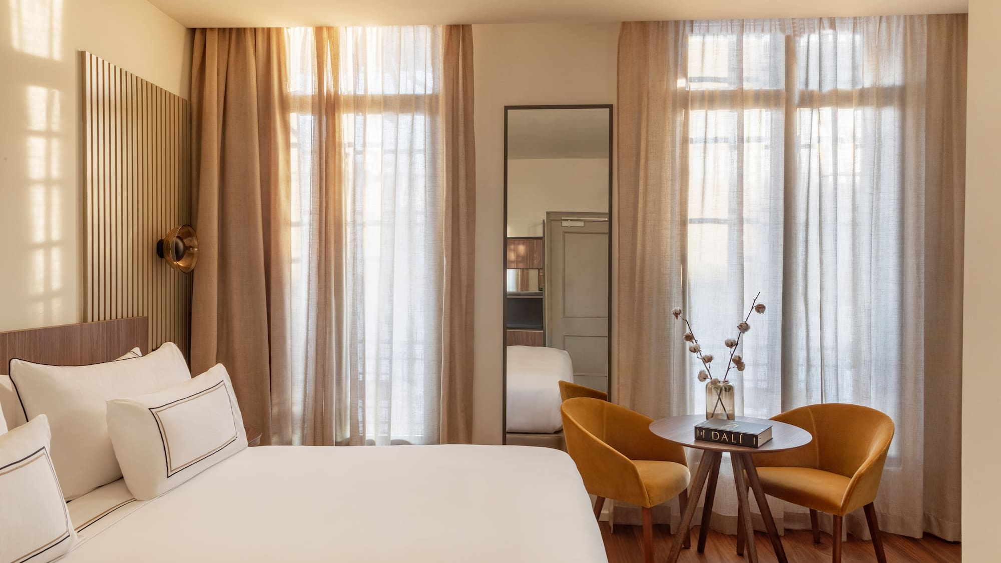 a room with a bed and chairs