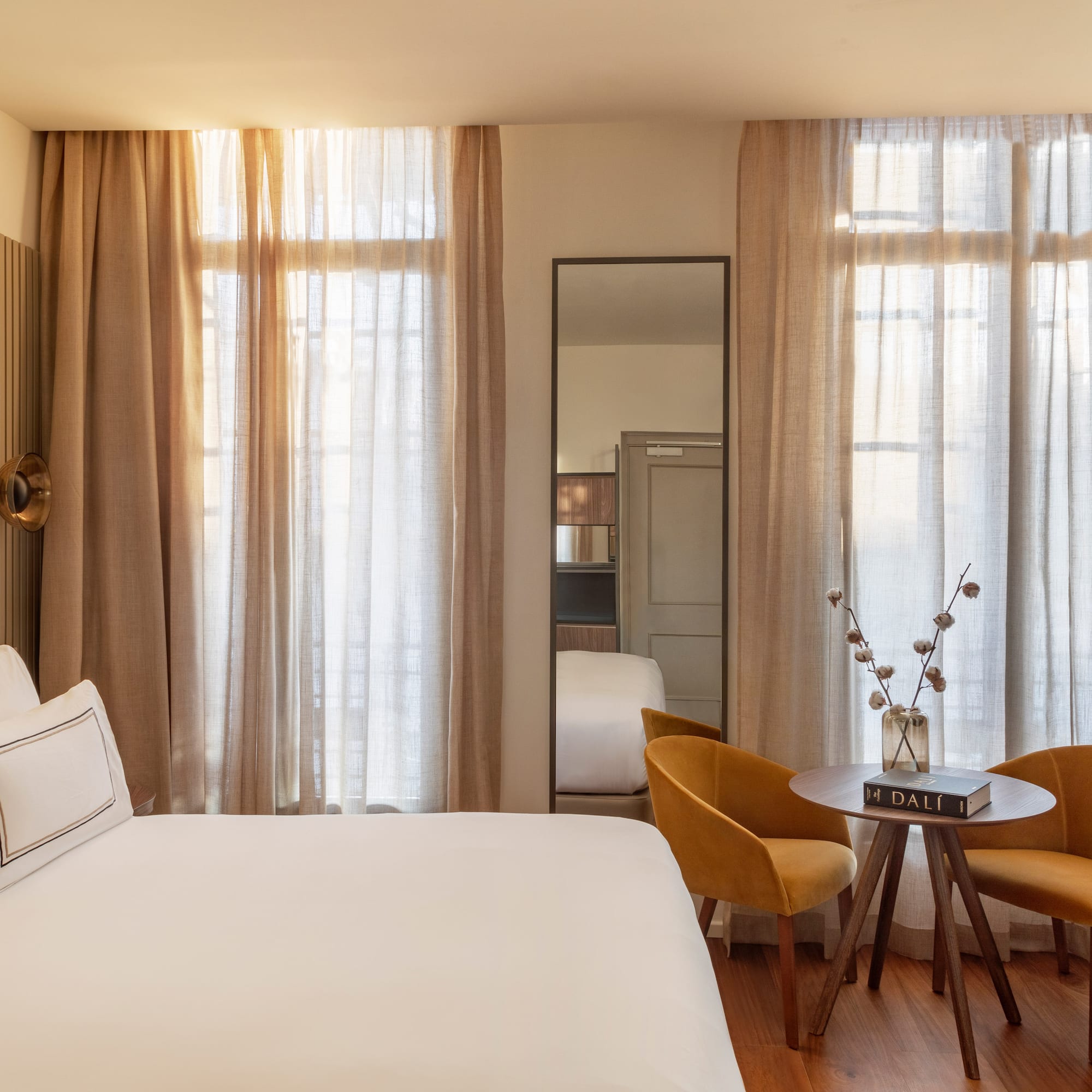 a room with a bed and chairs