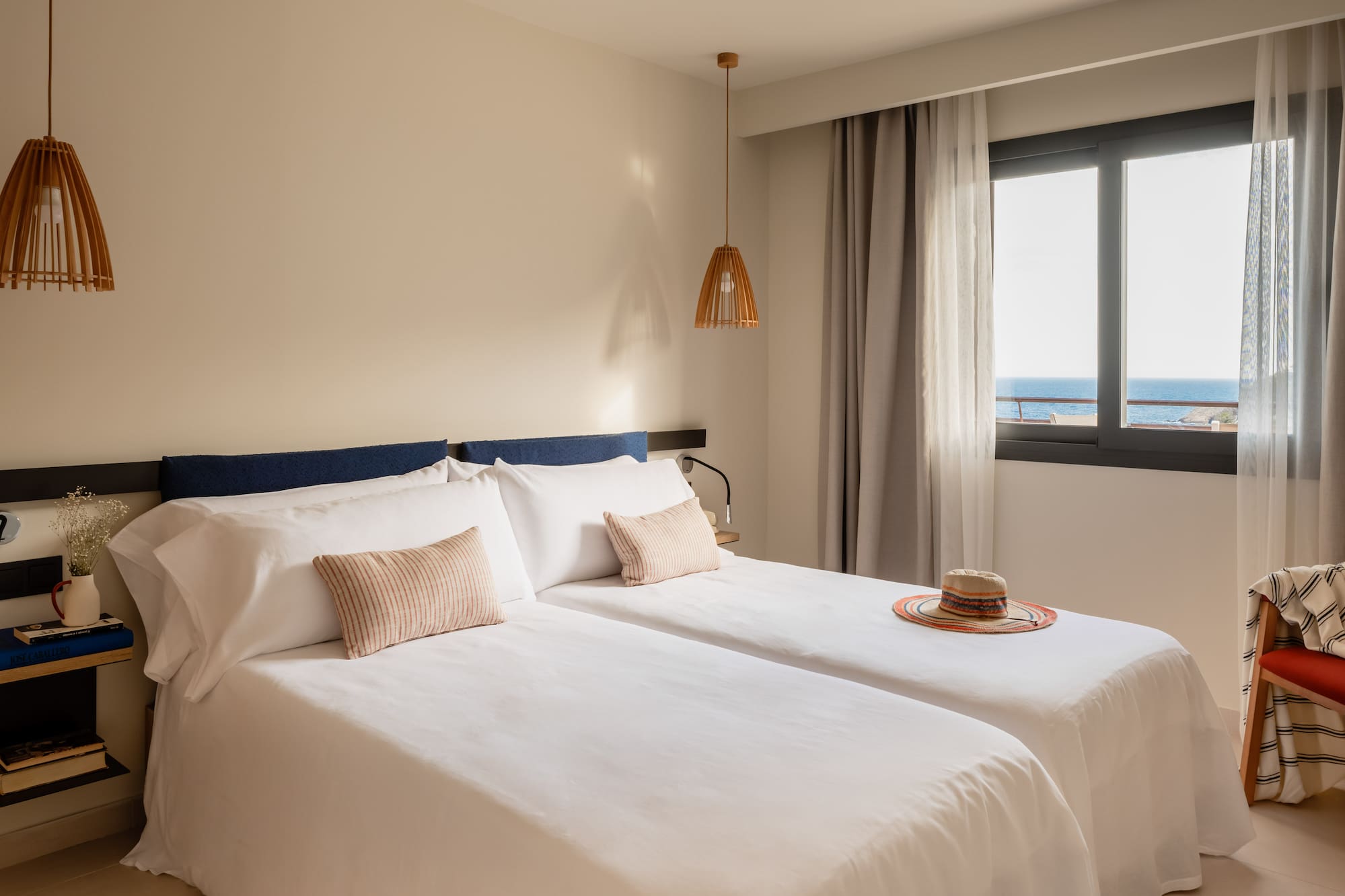 a room with two beds and a hat on the side