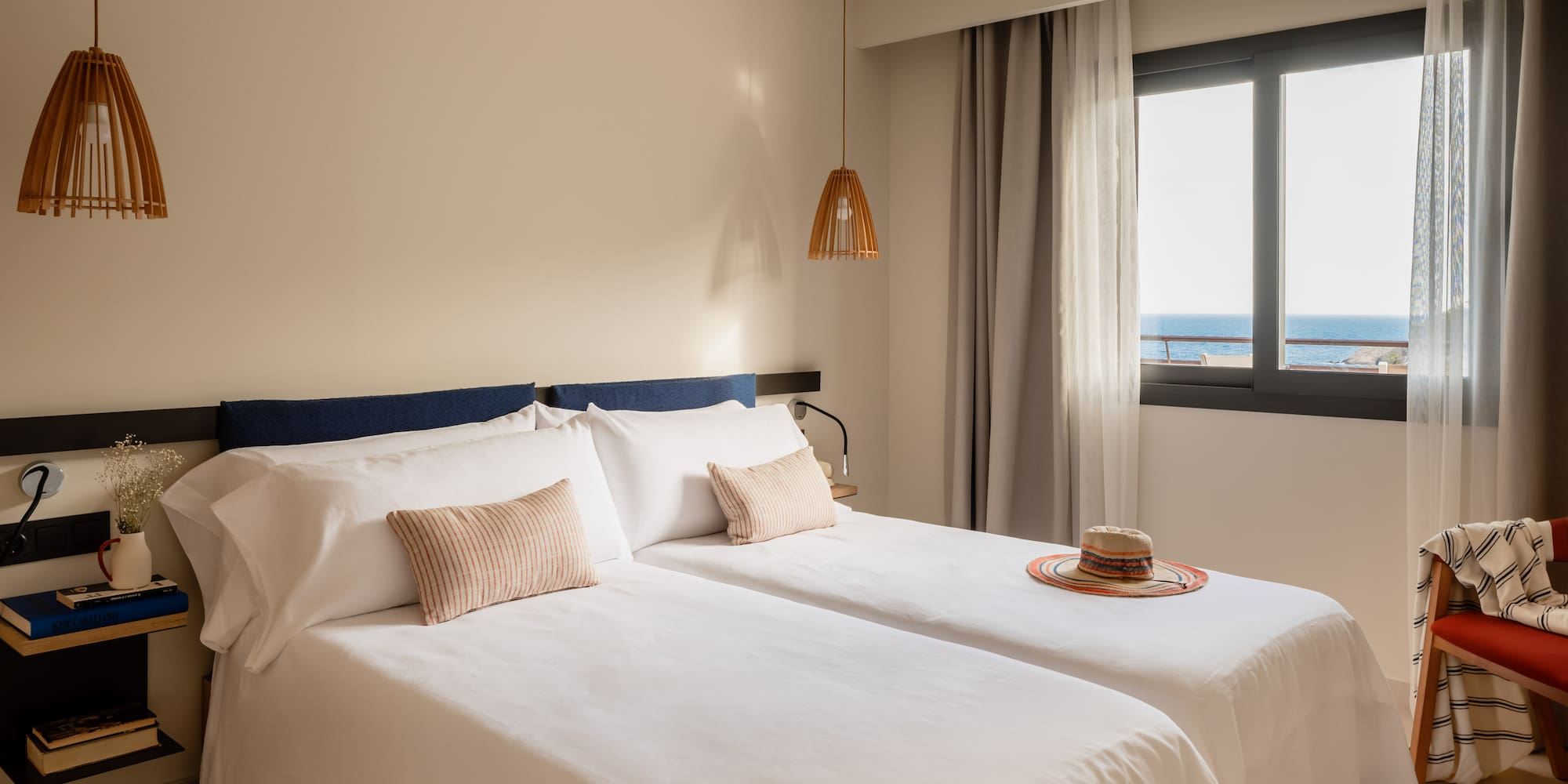 a room with two beds and a hat on the side