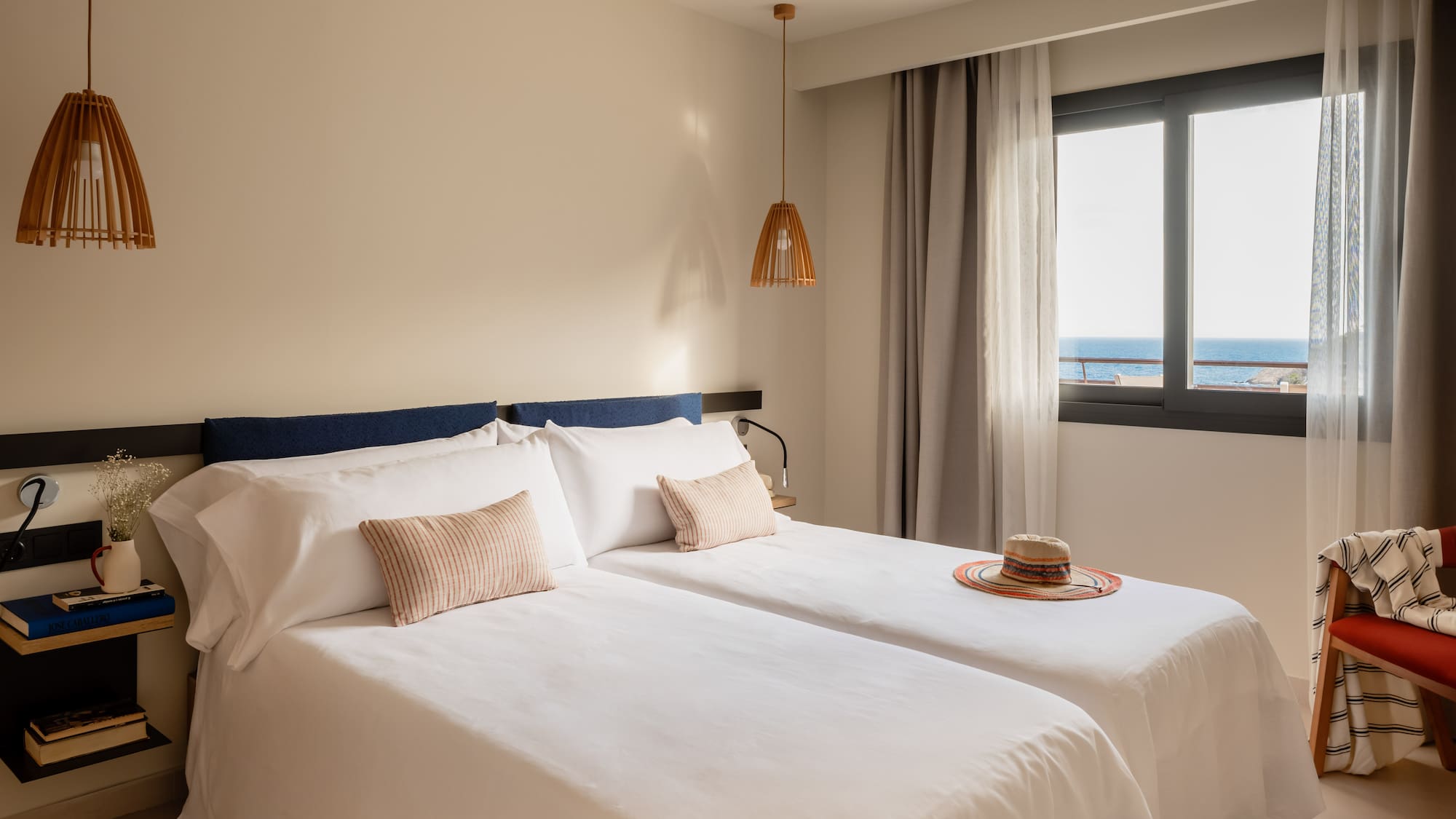 a room with two beds and a hat on the side