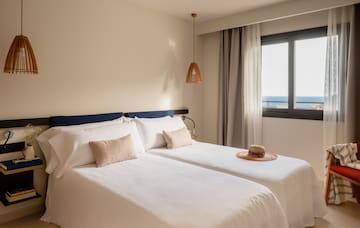 a room with two beds and a hat on the side