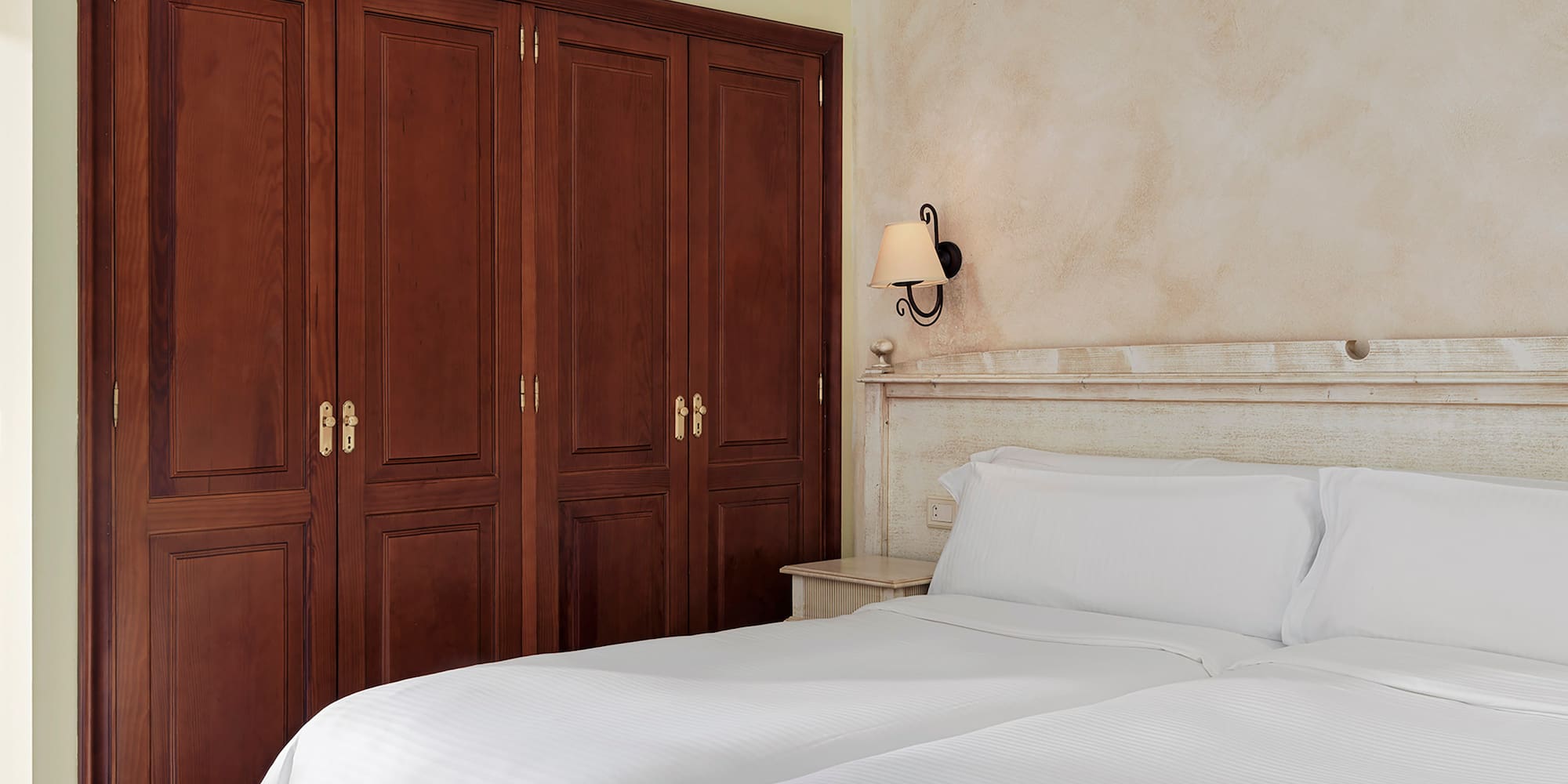 a room with two beds and a ceiling fan