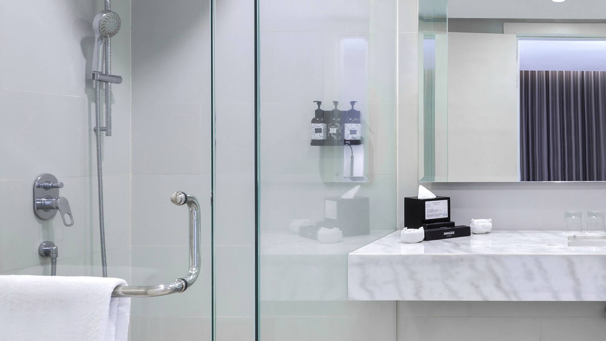 a bathroom with a shower and sink