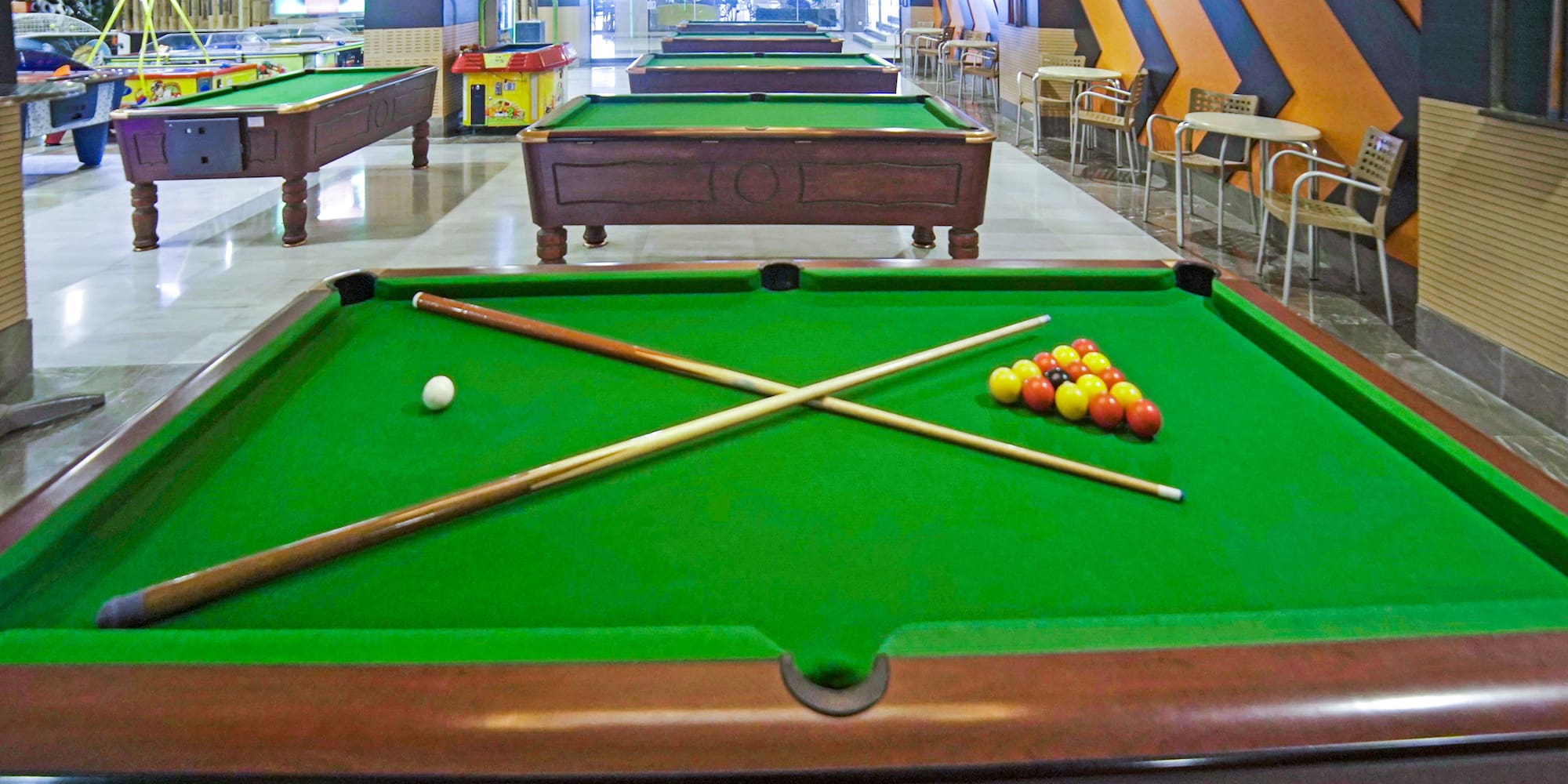 pool tables with balls and sticks on it