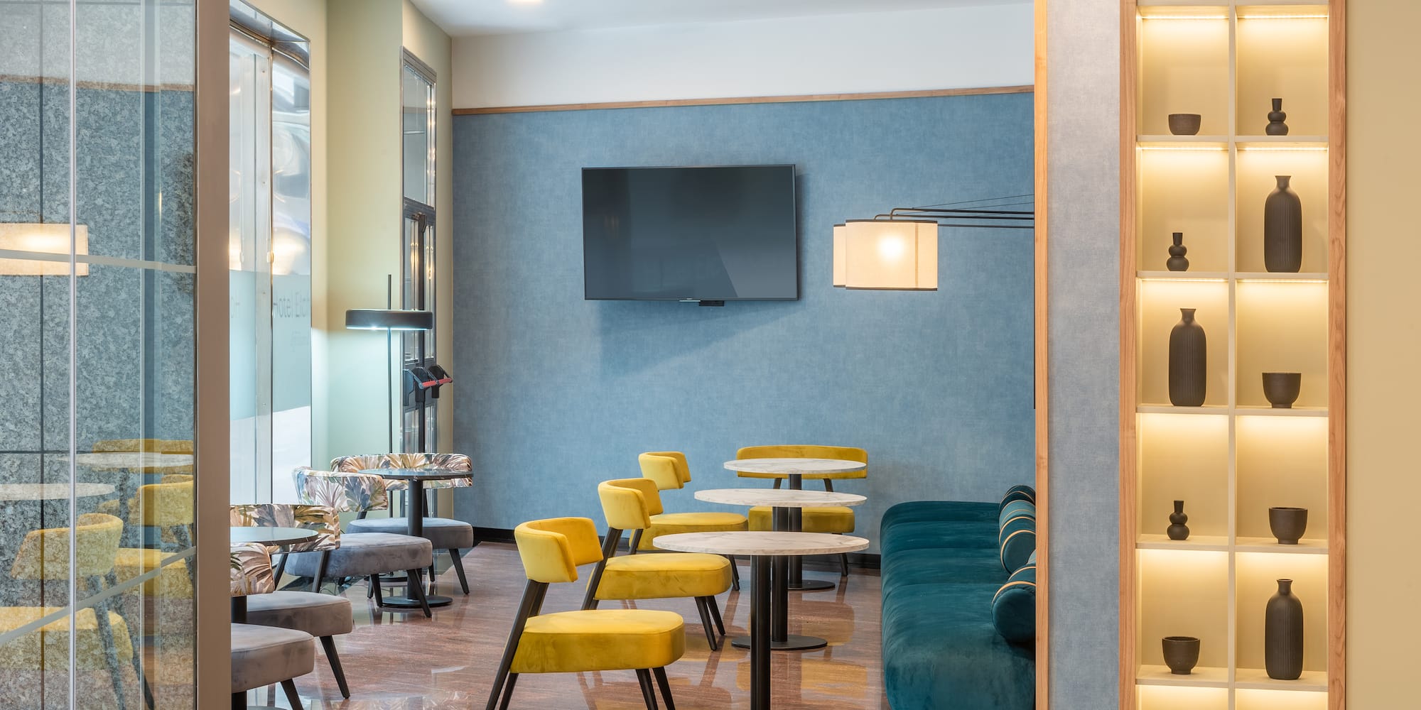 a room with a tv and tables