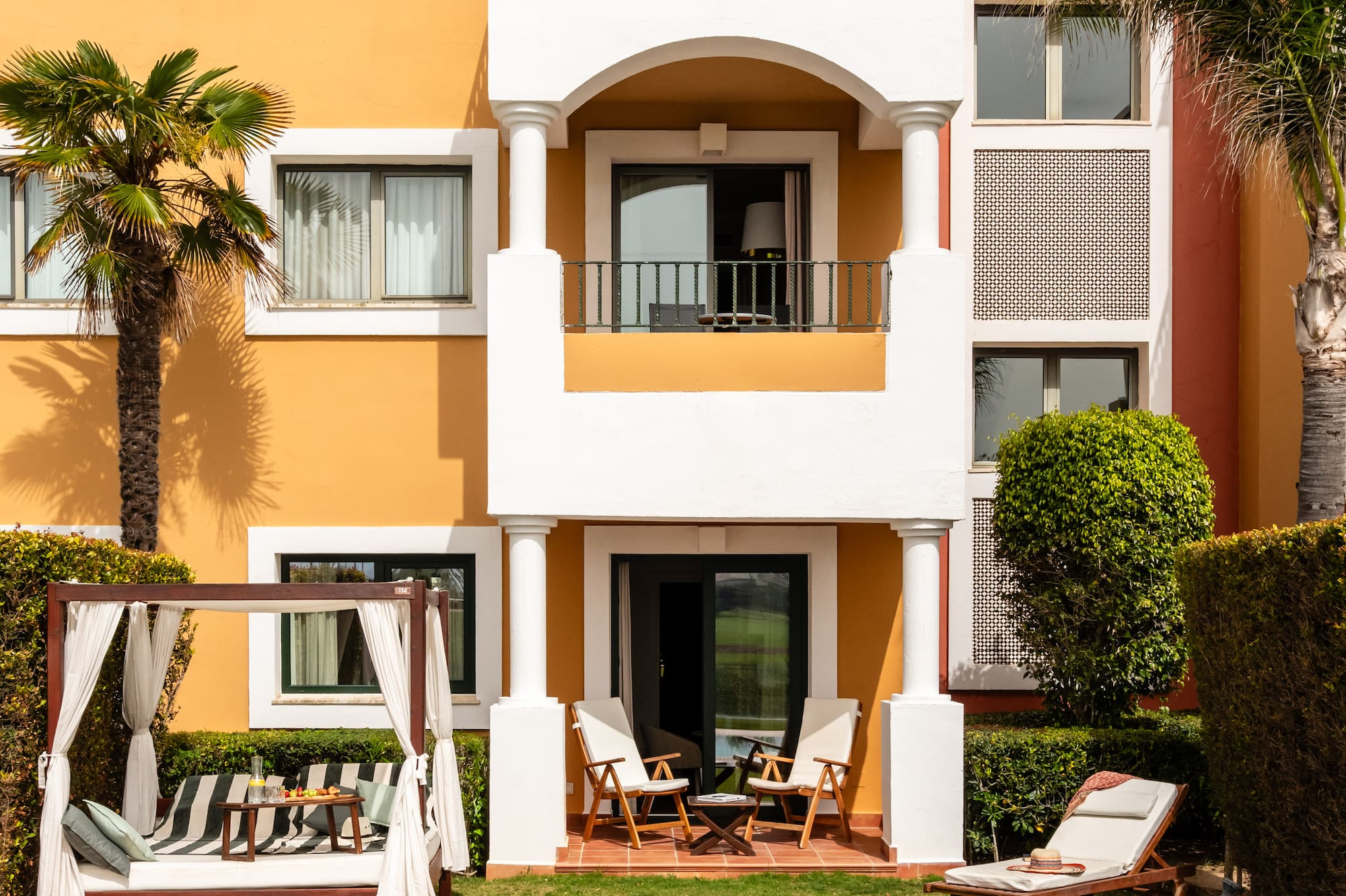 a building with a pool and chairs