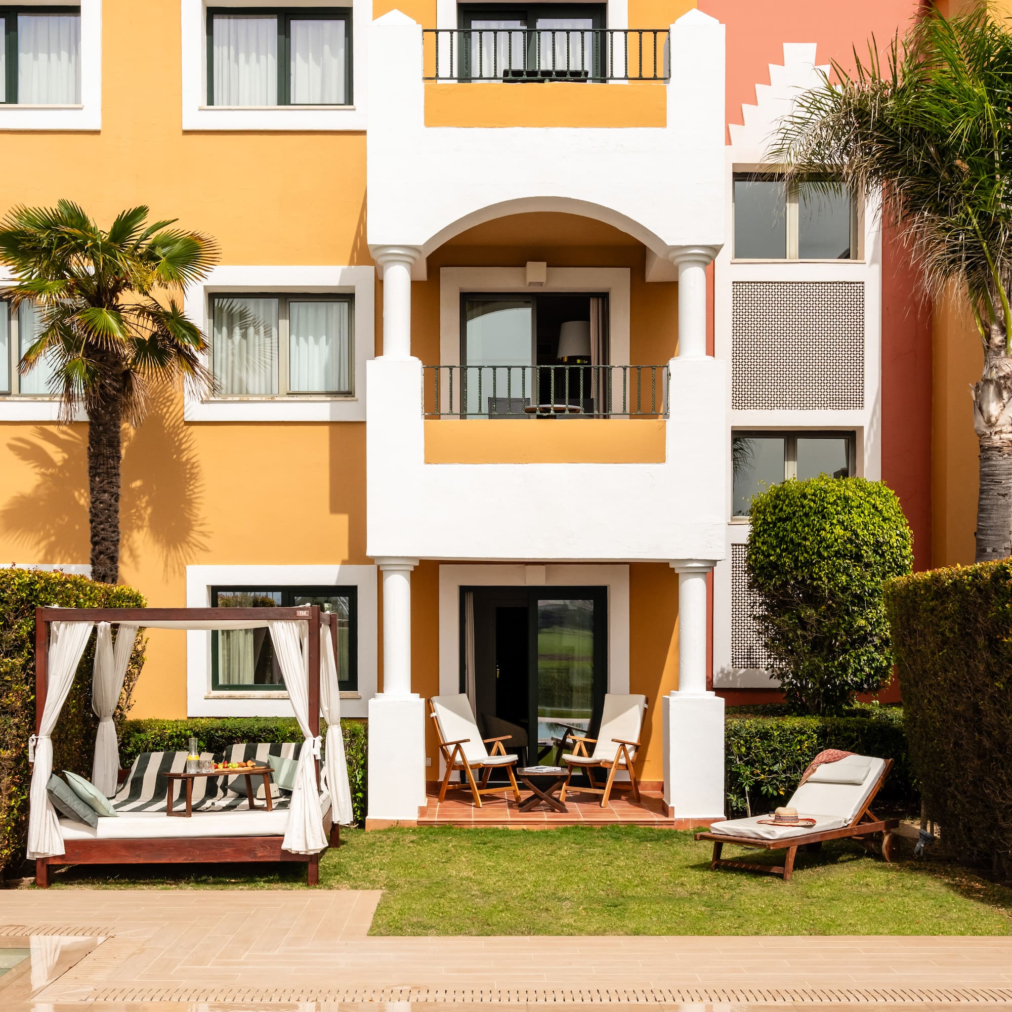 a building with a pool and chairs