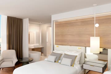 a bedroom with a bed and a tub